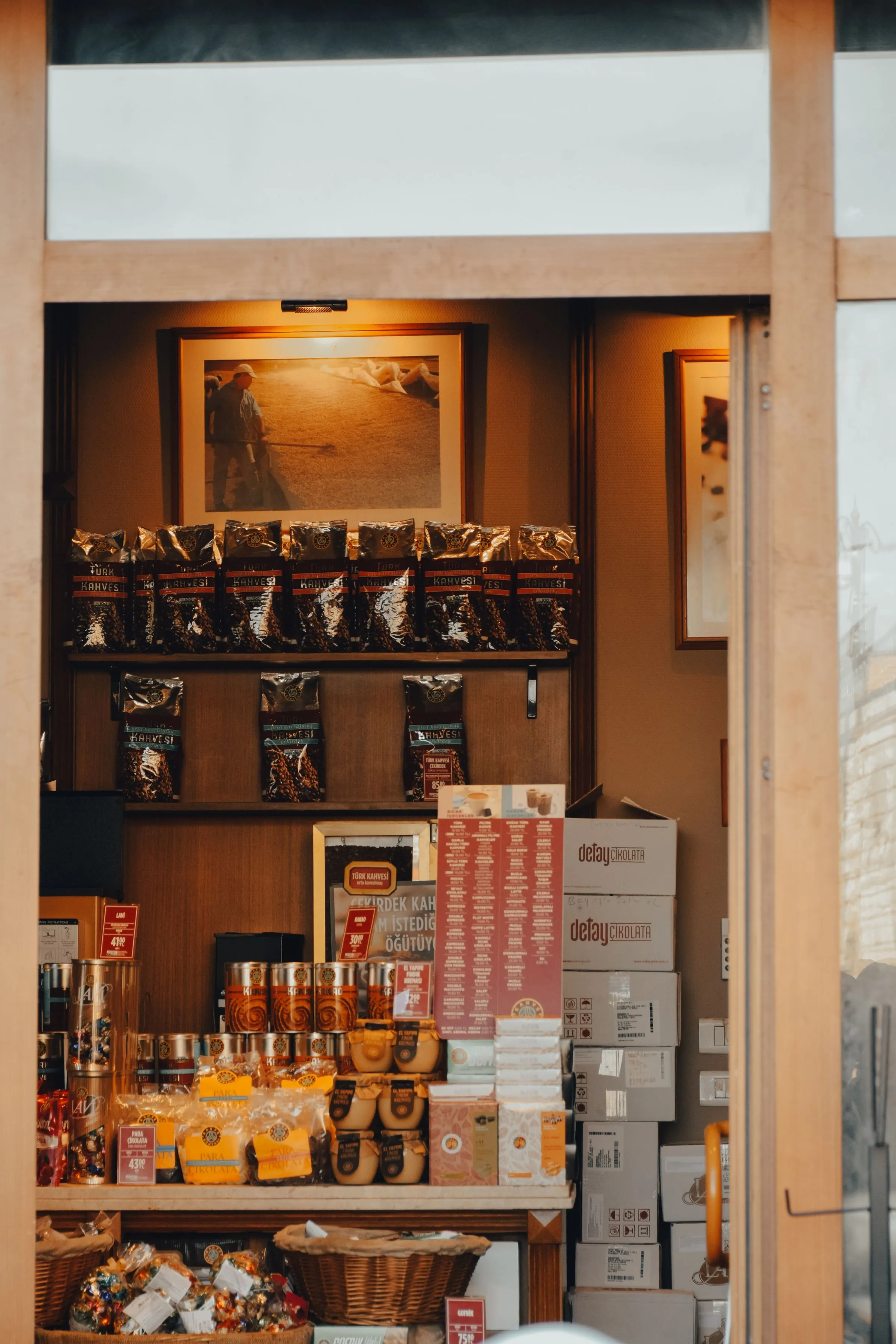 Counter at Forma Café with shelves of coffee packaging and warm timber surfaces.