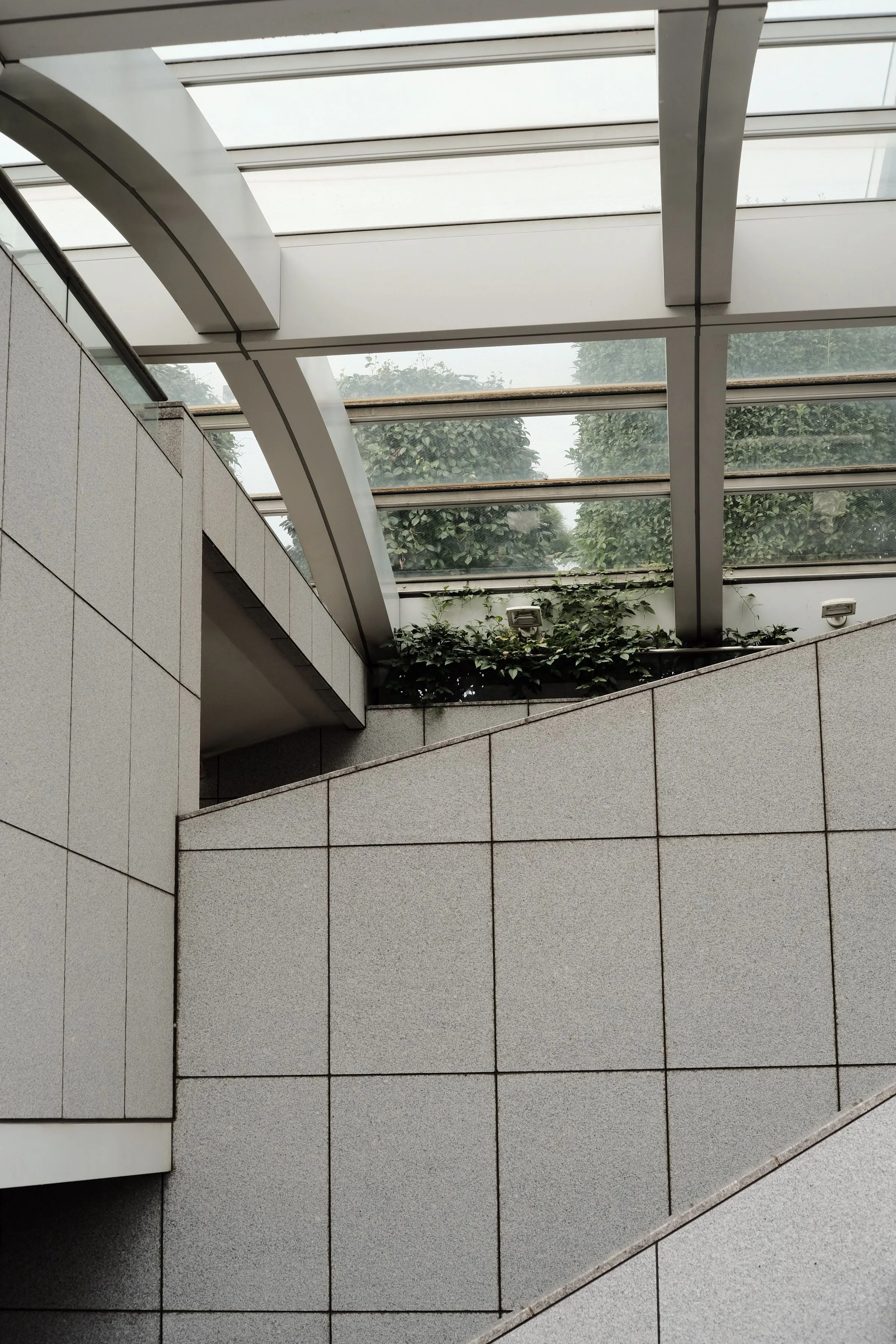 An interior lit from a skylight, with geometric structure overhead.