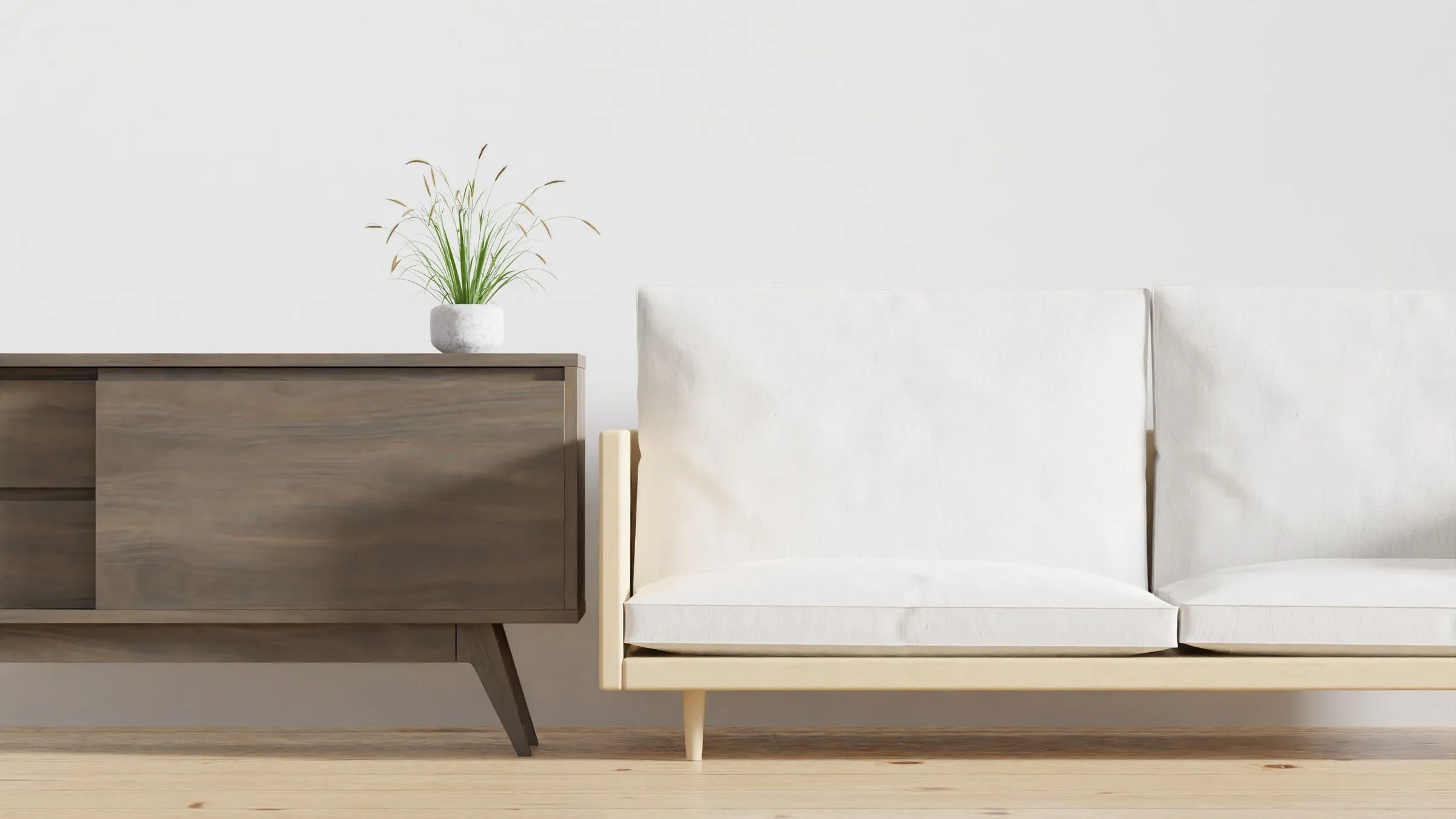 Living room at Casa Terra with a low wooden console, a potted plant and a beige sofa.