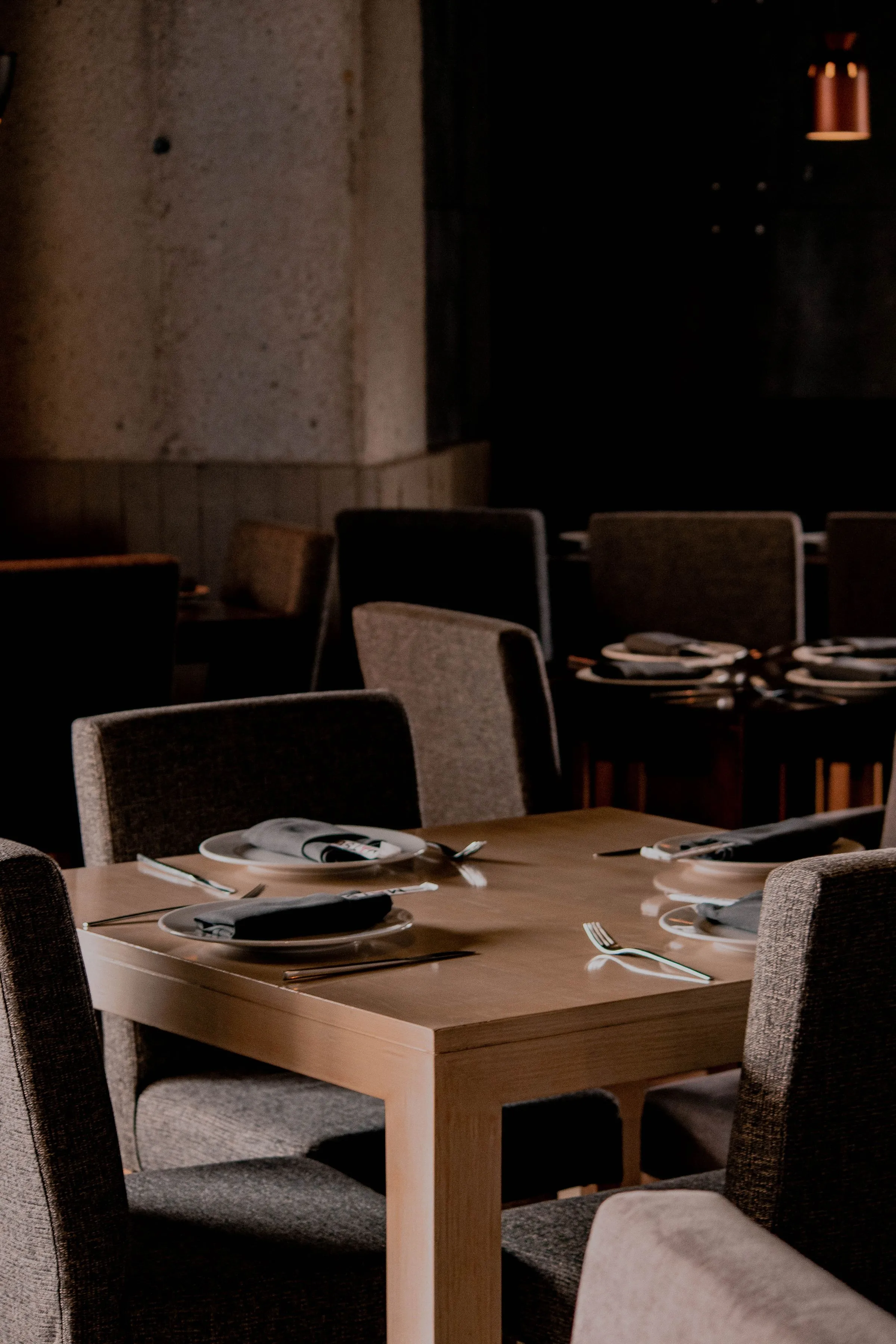 Private dining room at The Salt Room set with glassware and upholstered chairs.