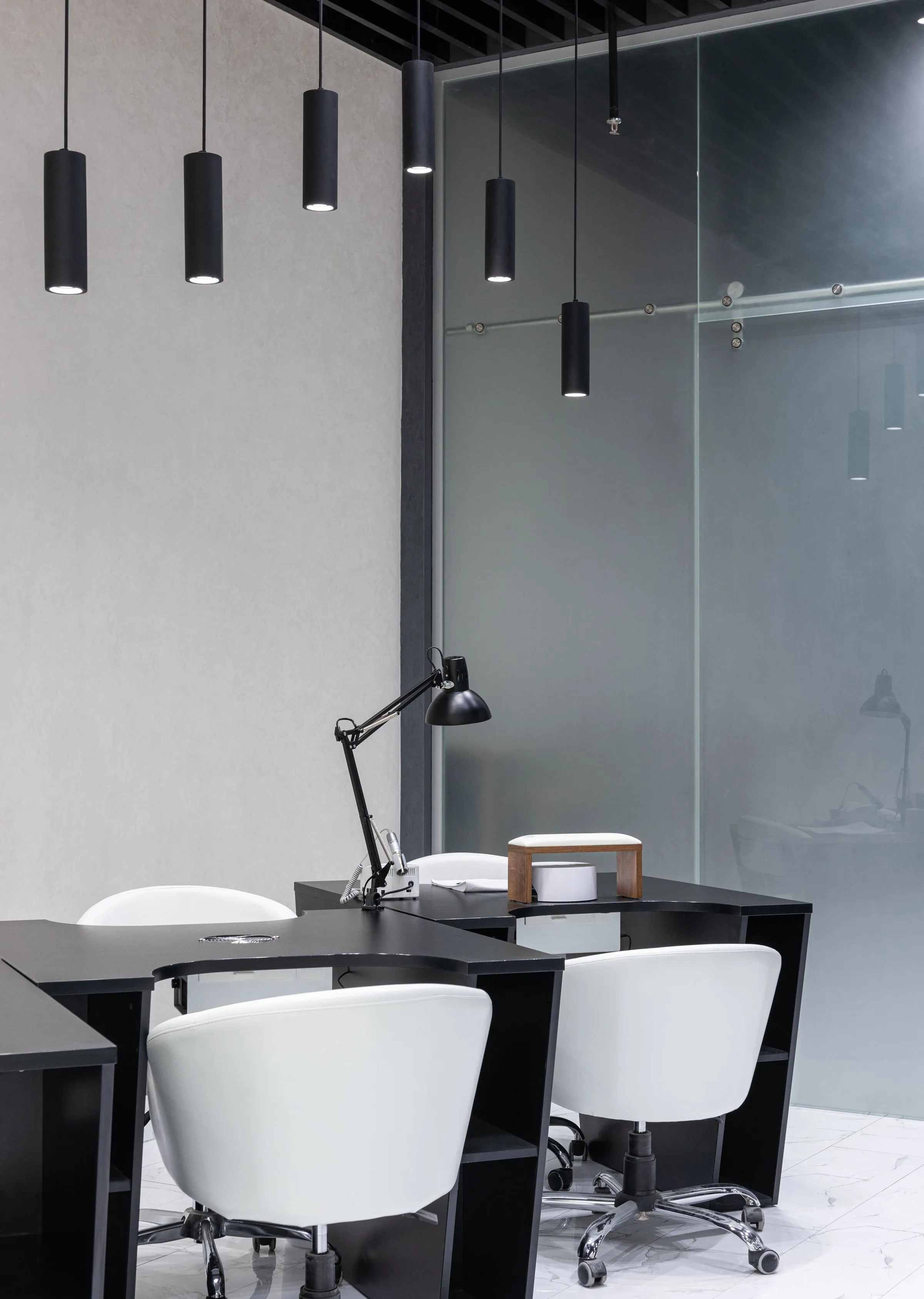 Dark timber booth seating at Atelier 27 under low pendant lights.
