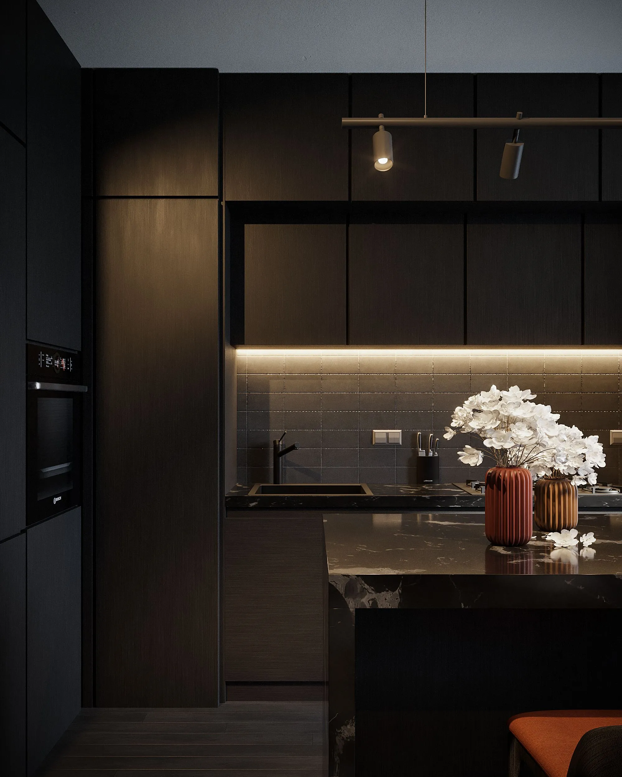 A dark kitchen with illuminated cabinetry and a stone island.