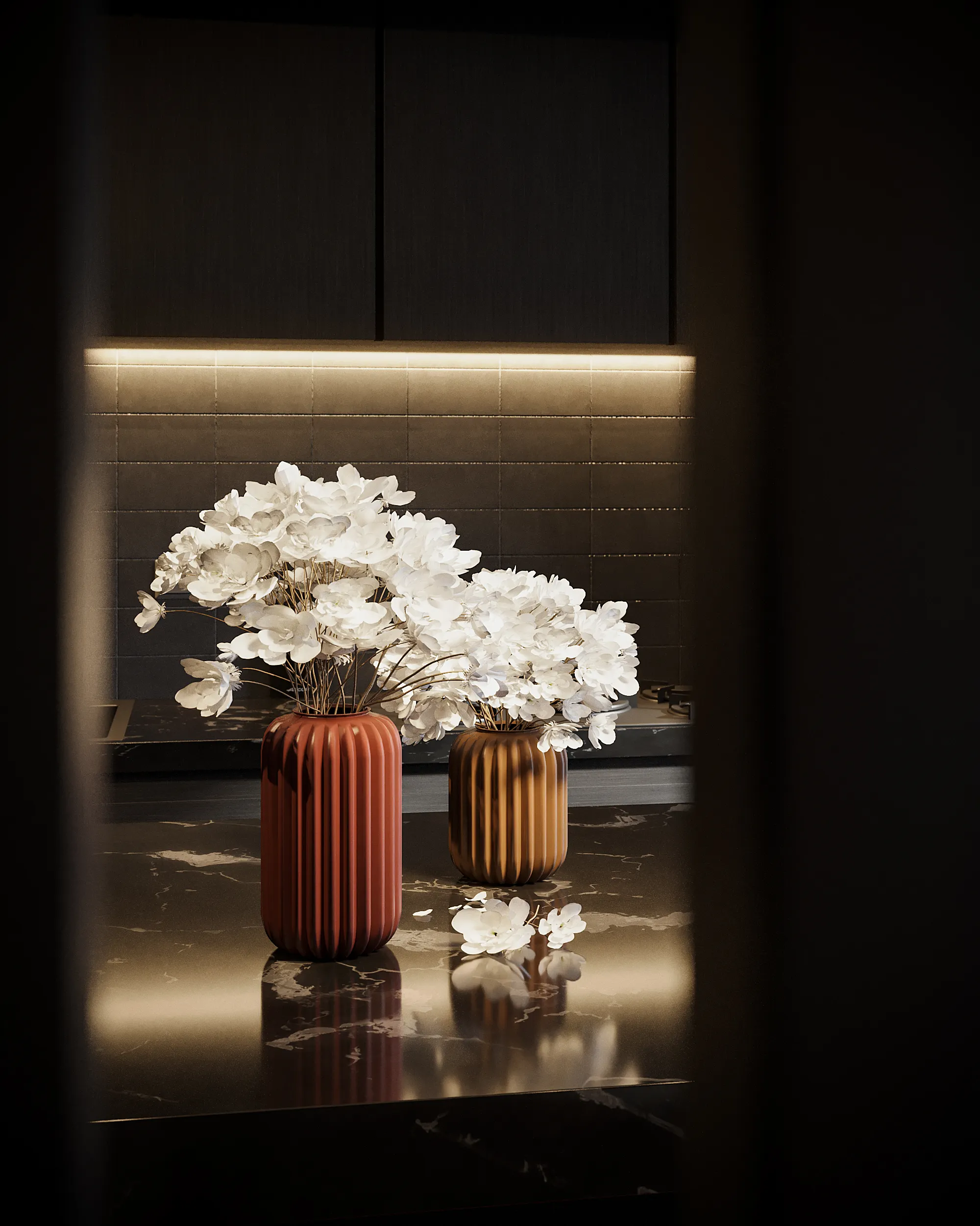 A contemporary interior with cut flowers in vases on a polished surface.
