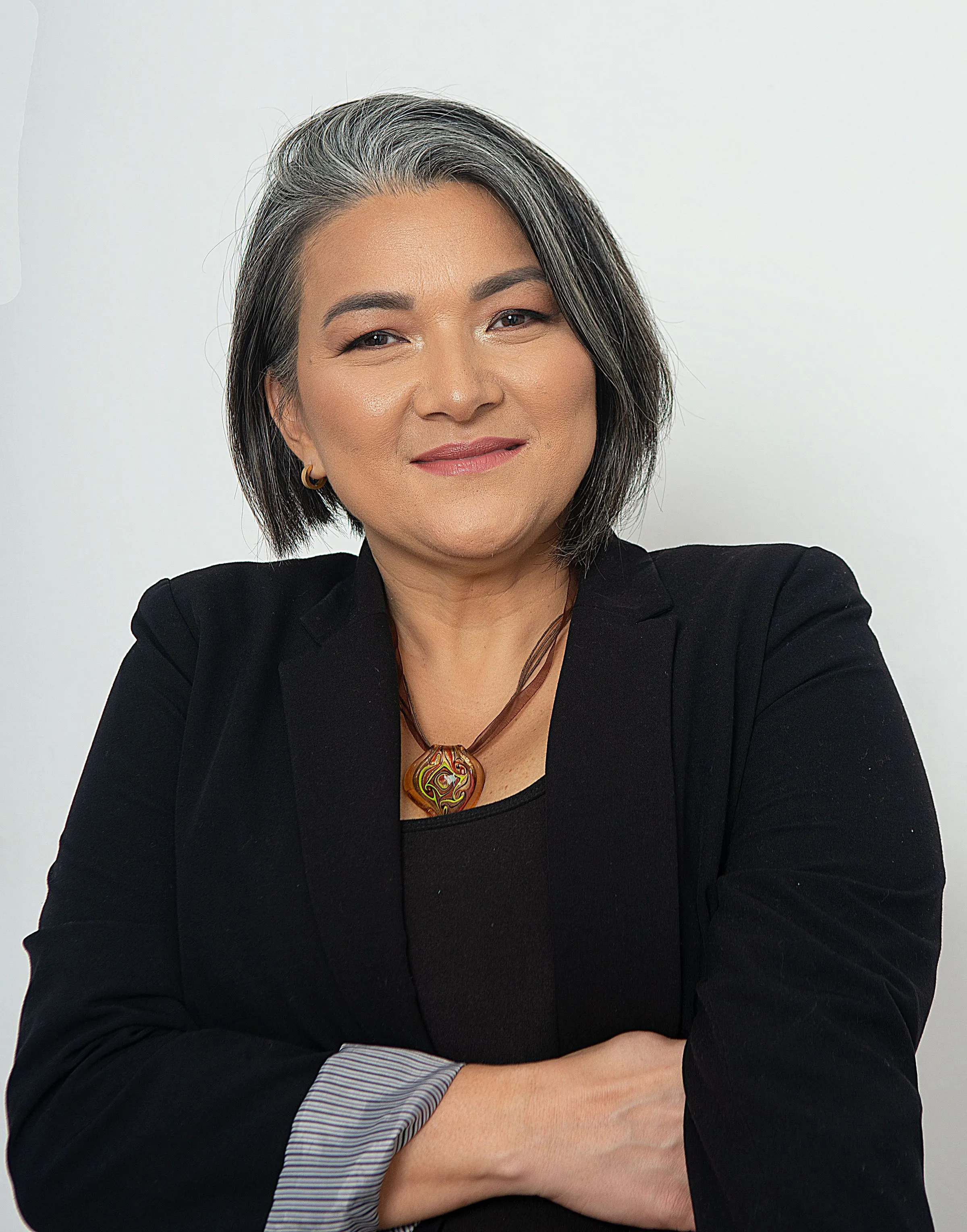 Portrait of Meera Anand, founder of ARCADÉ STUDIO, standing with her arms folded.