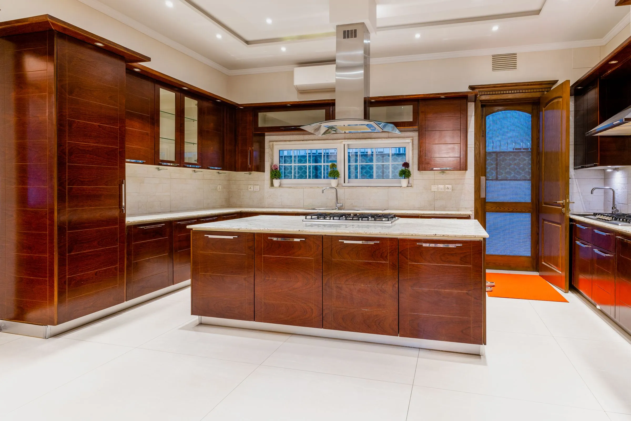 Kitchen at The Oak House with dark timber cabinetry and a marble worktop.