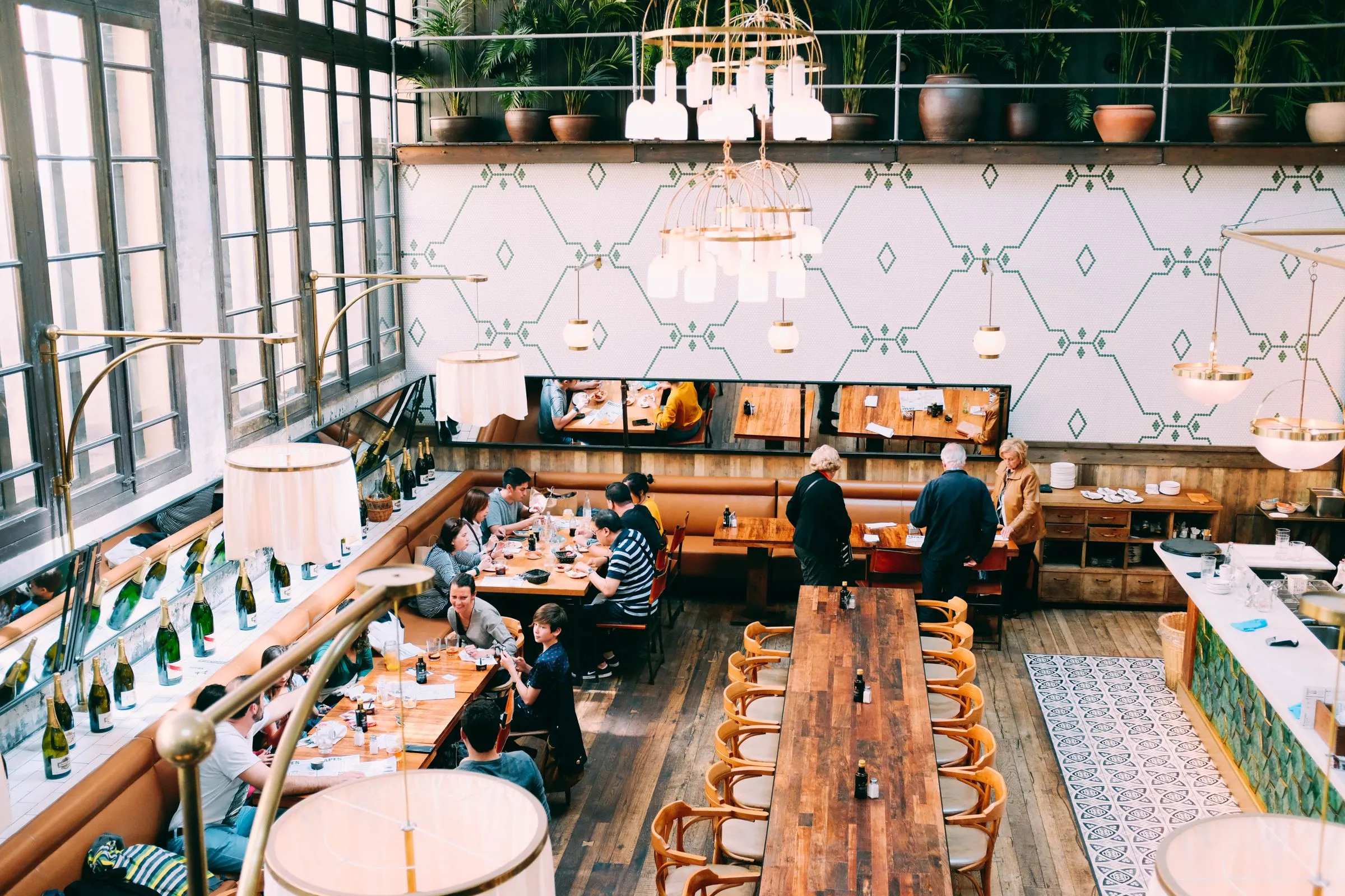 Dining room at The Salt Room with timber tables laid for service and guests seated.