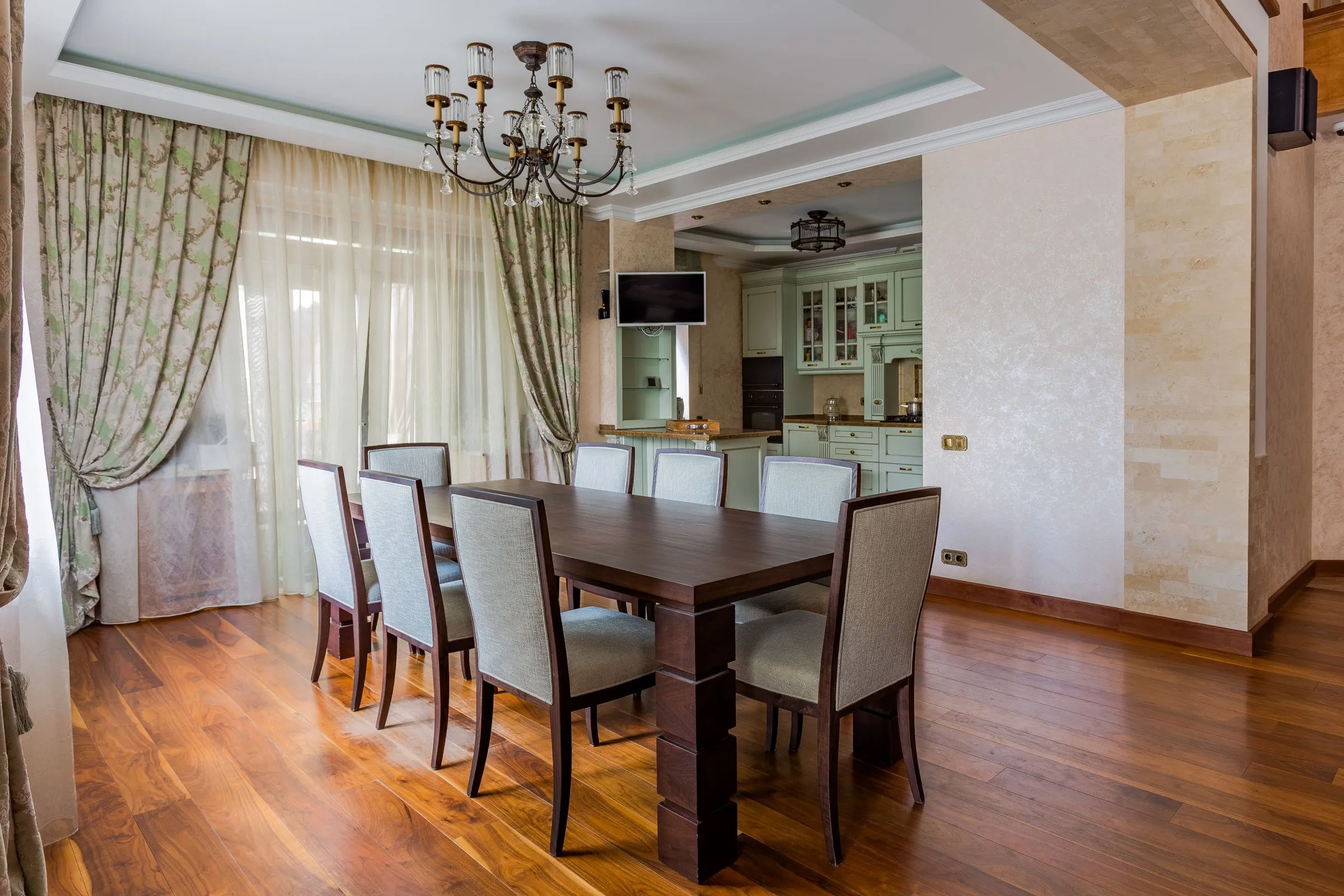 Dining room at Maison No. 8 with a dark timber table, upholstered chairs and low lighting.
