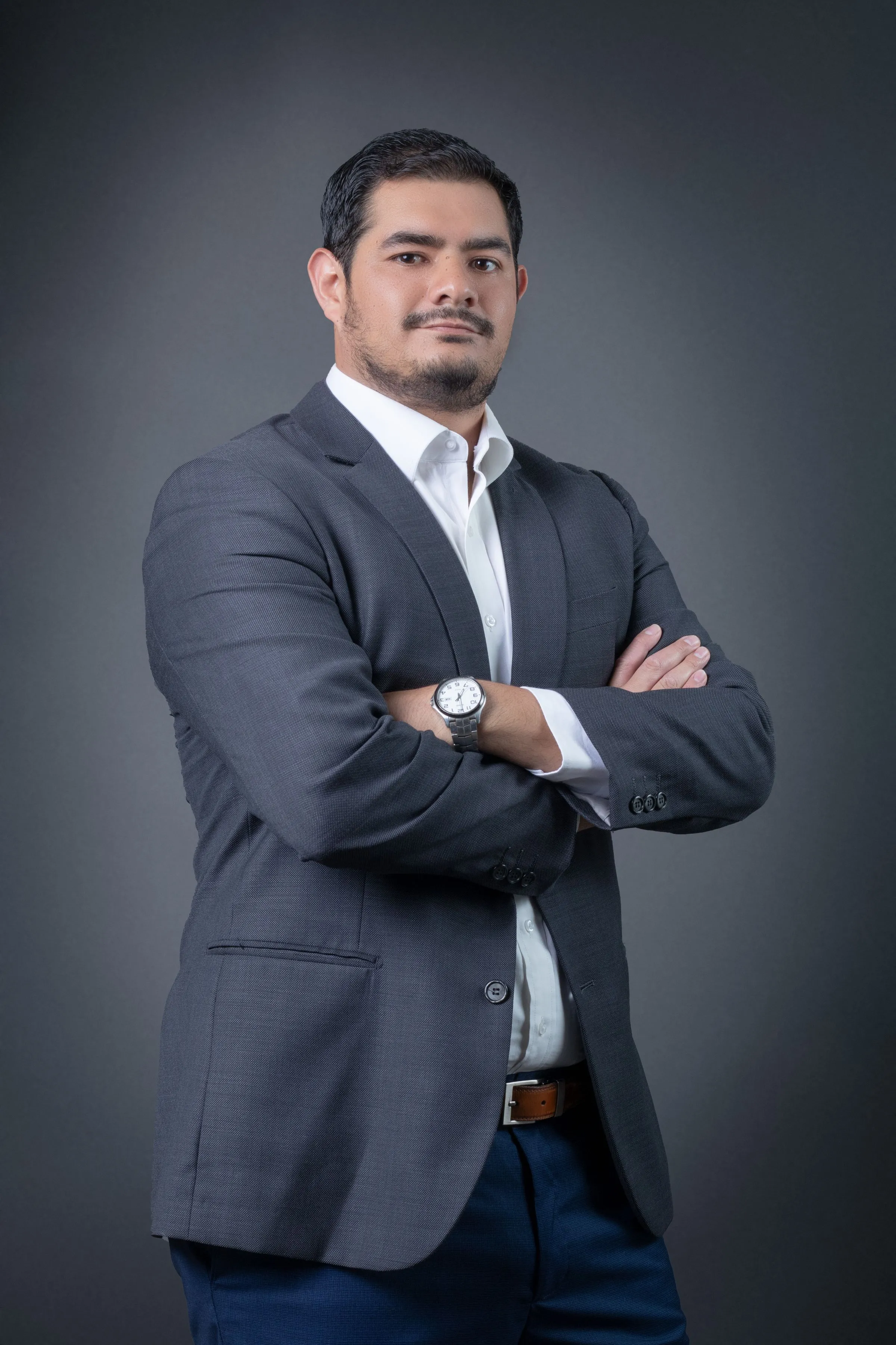 Portrait of Farhan Qureshi, materials specialist, with his arms folded.