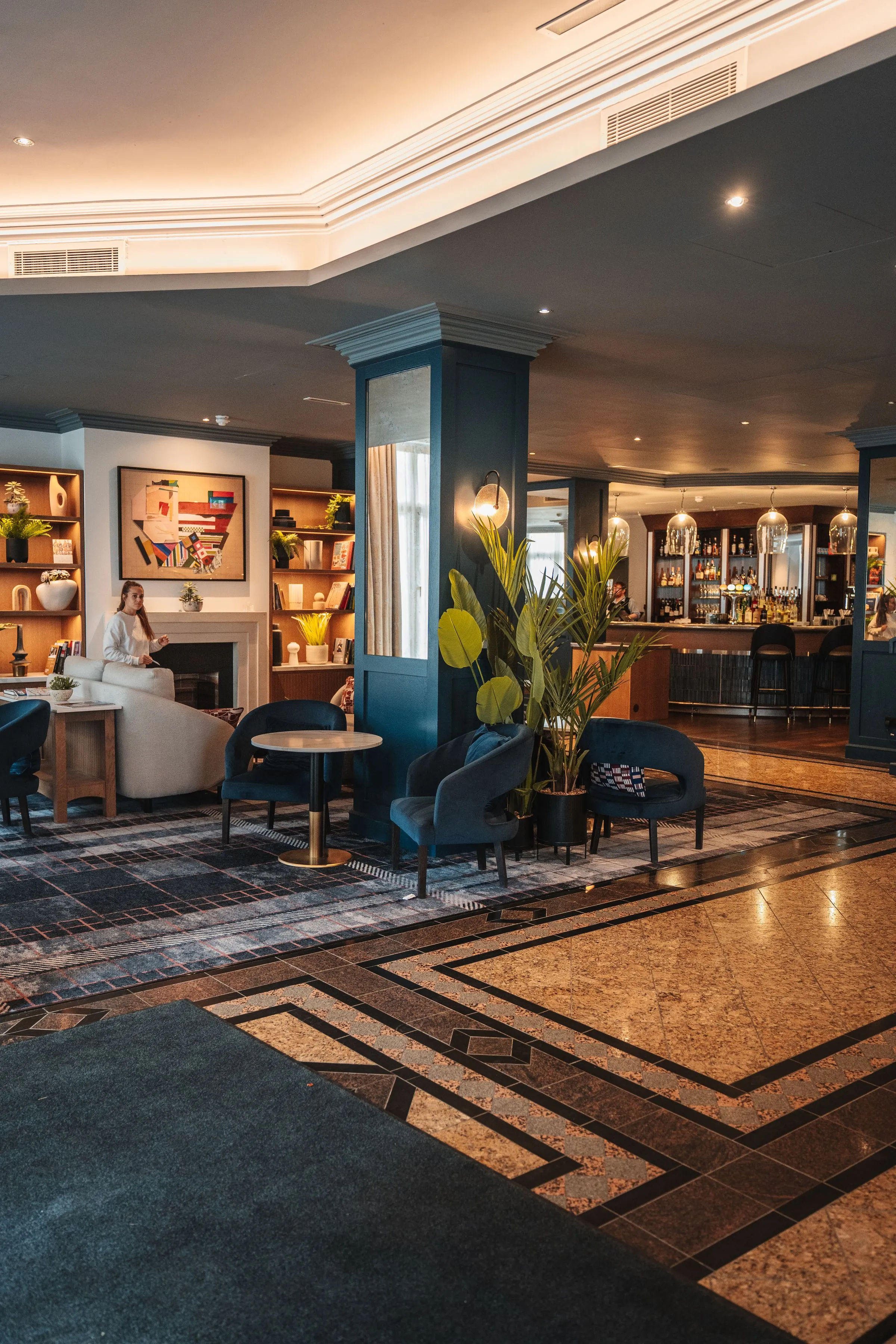 Lounge at Hotel Marana with upholstered seating, artwork and warm lighting.