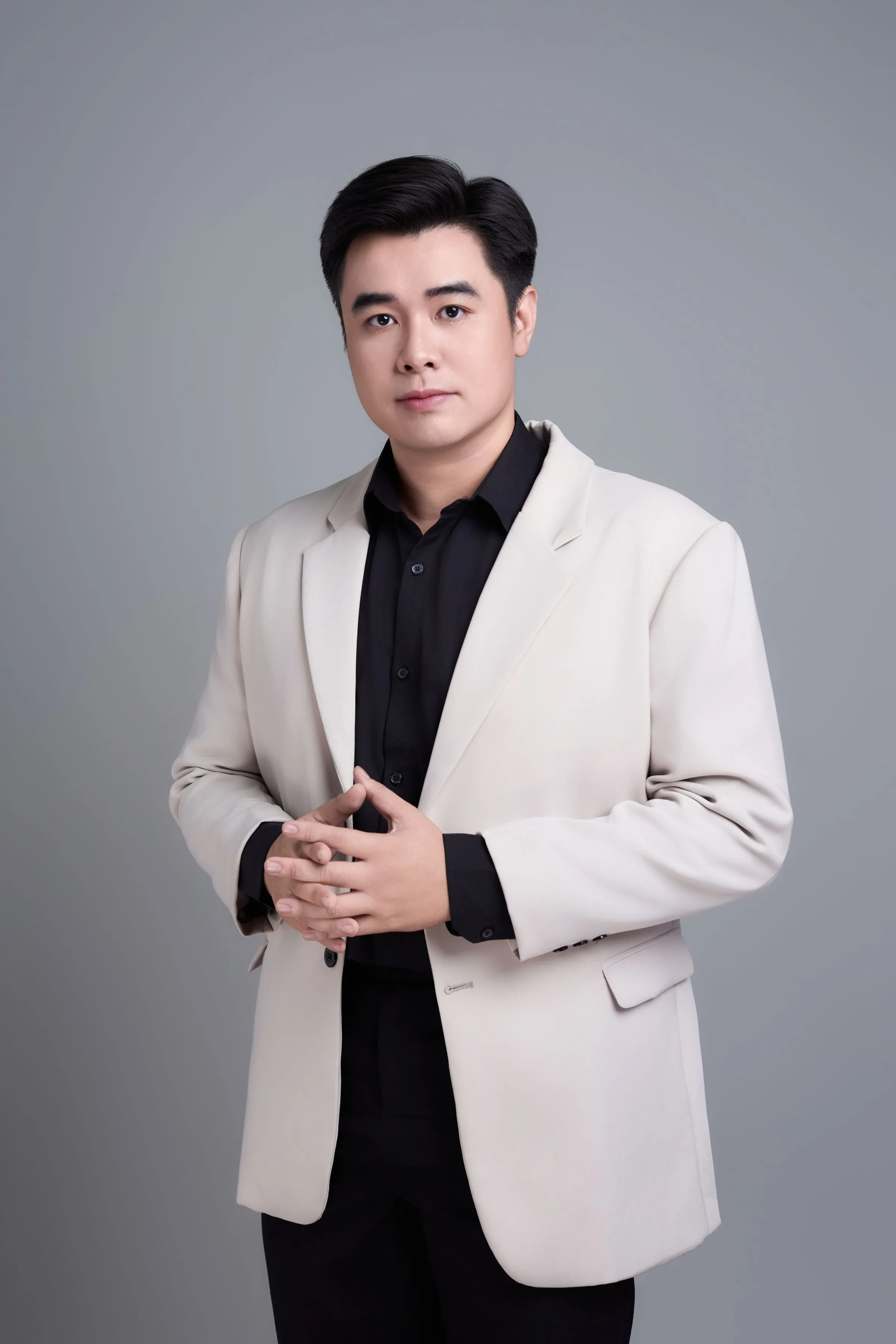 Portrait of Ishan Kurup, project architect, in a dark suit against a plain backdrop.