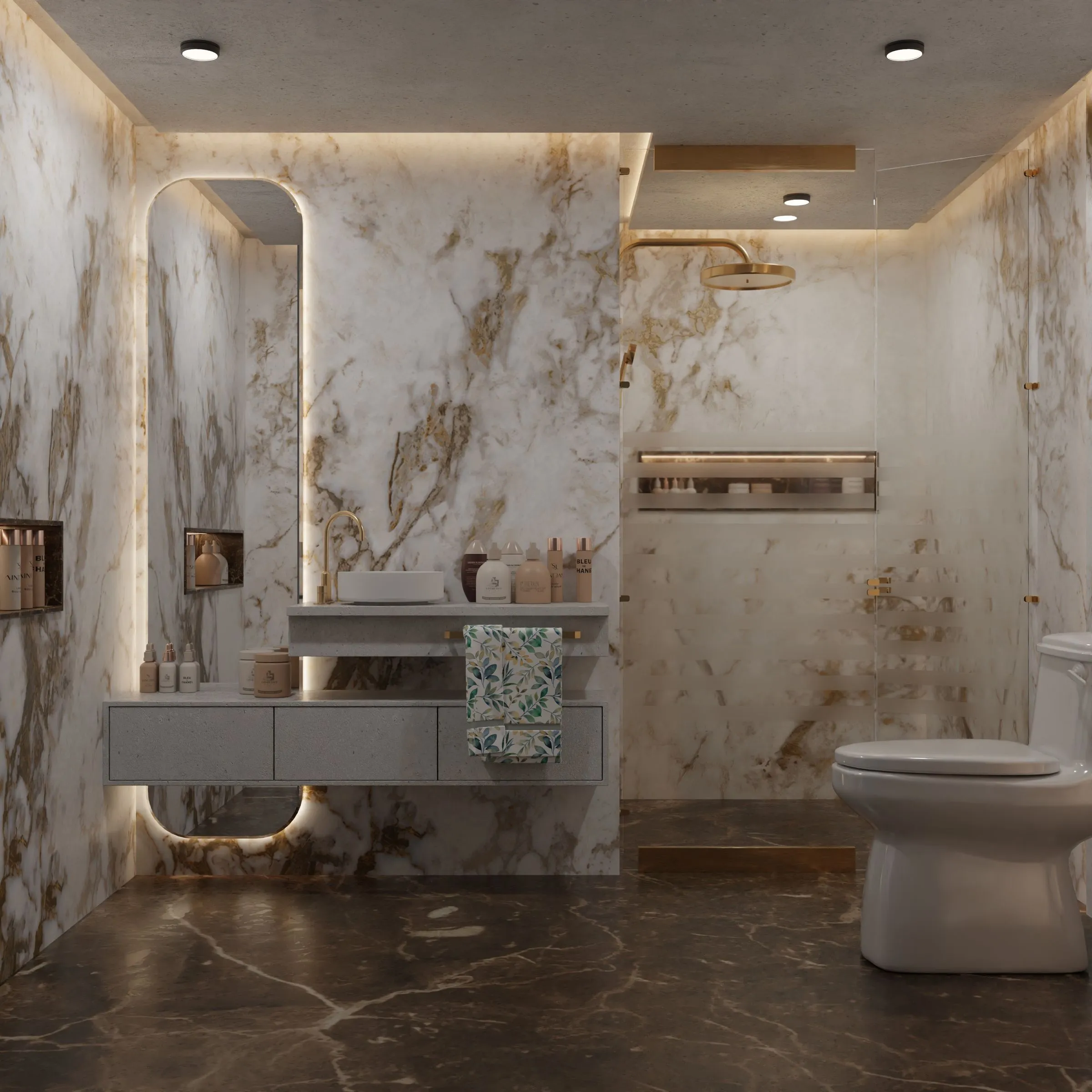 A bathroom with marble walls, modern fittings and warm concealed lighting.