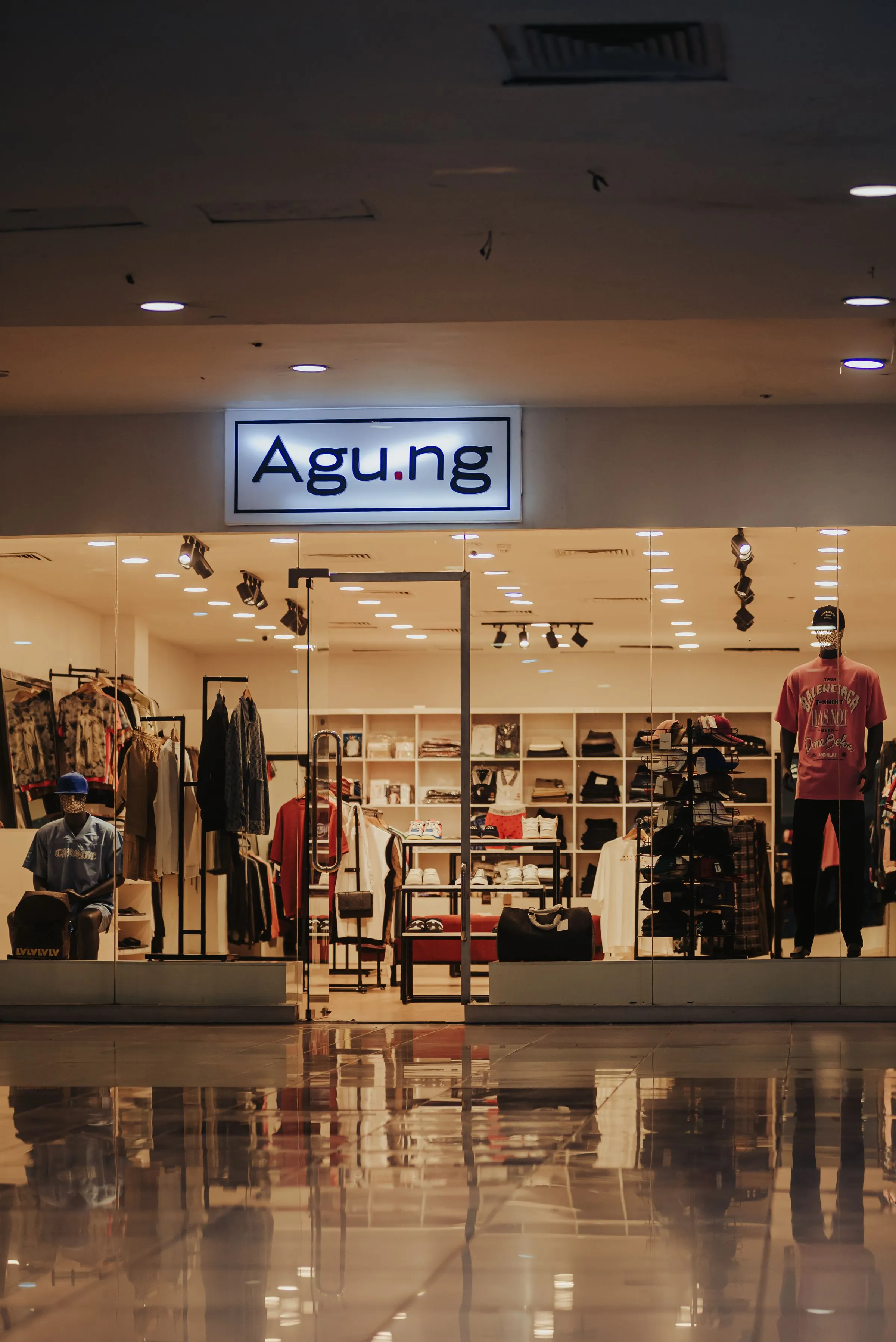 Vault & Vine shopfront area with clothing rails and a pale plastered wall.