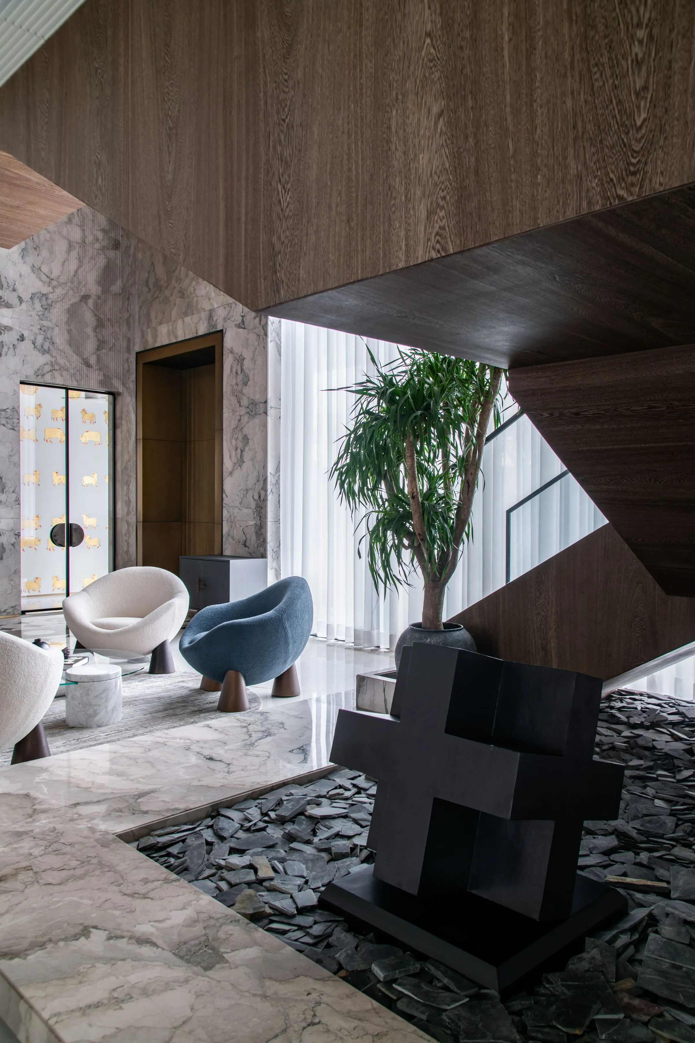 A living space with contemporary furniture and marble surfaces.