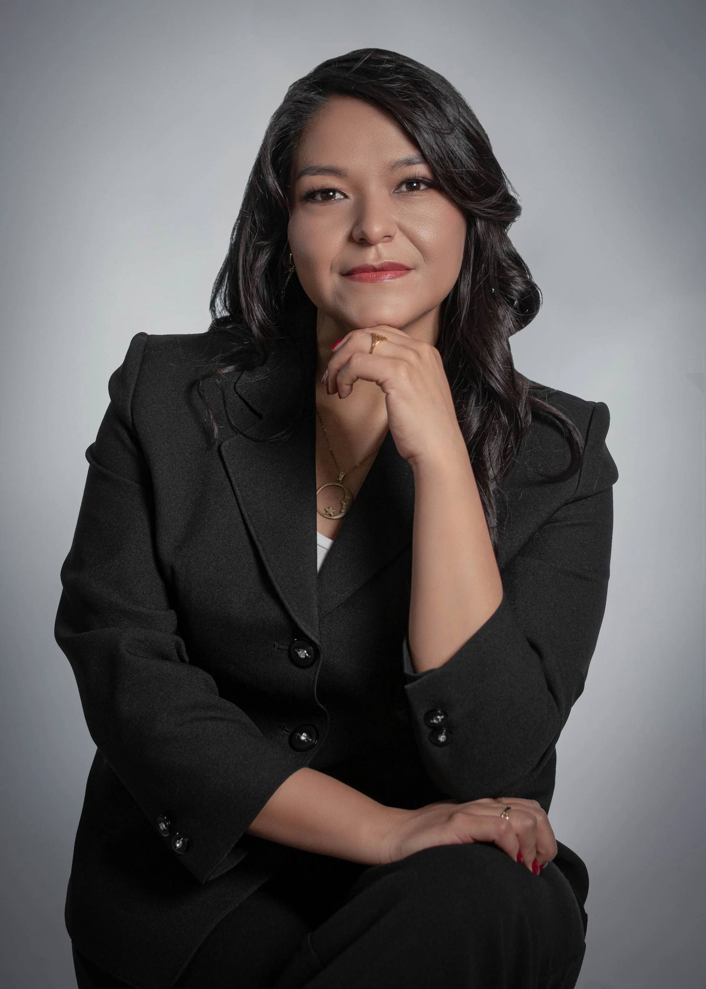 Portrait of Devika Raghunath, principal designer, against a plain backdrop.