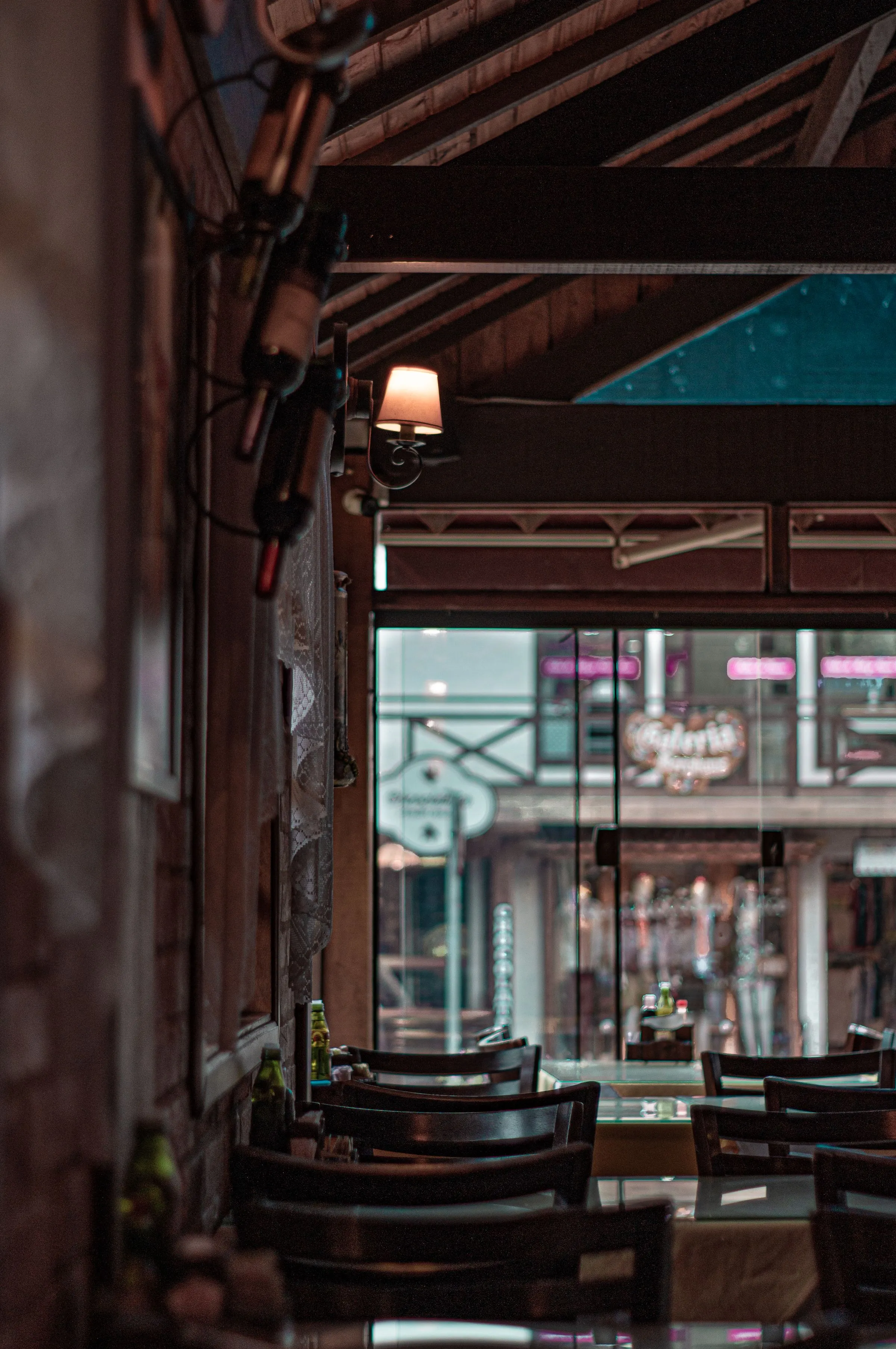 Bar at The Salt Room with bottles on timber shelving and warm downlighting.
