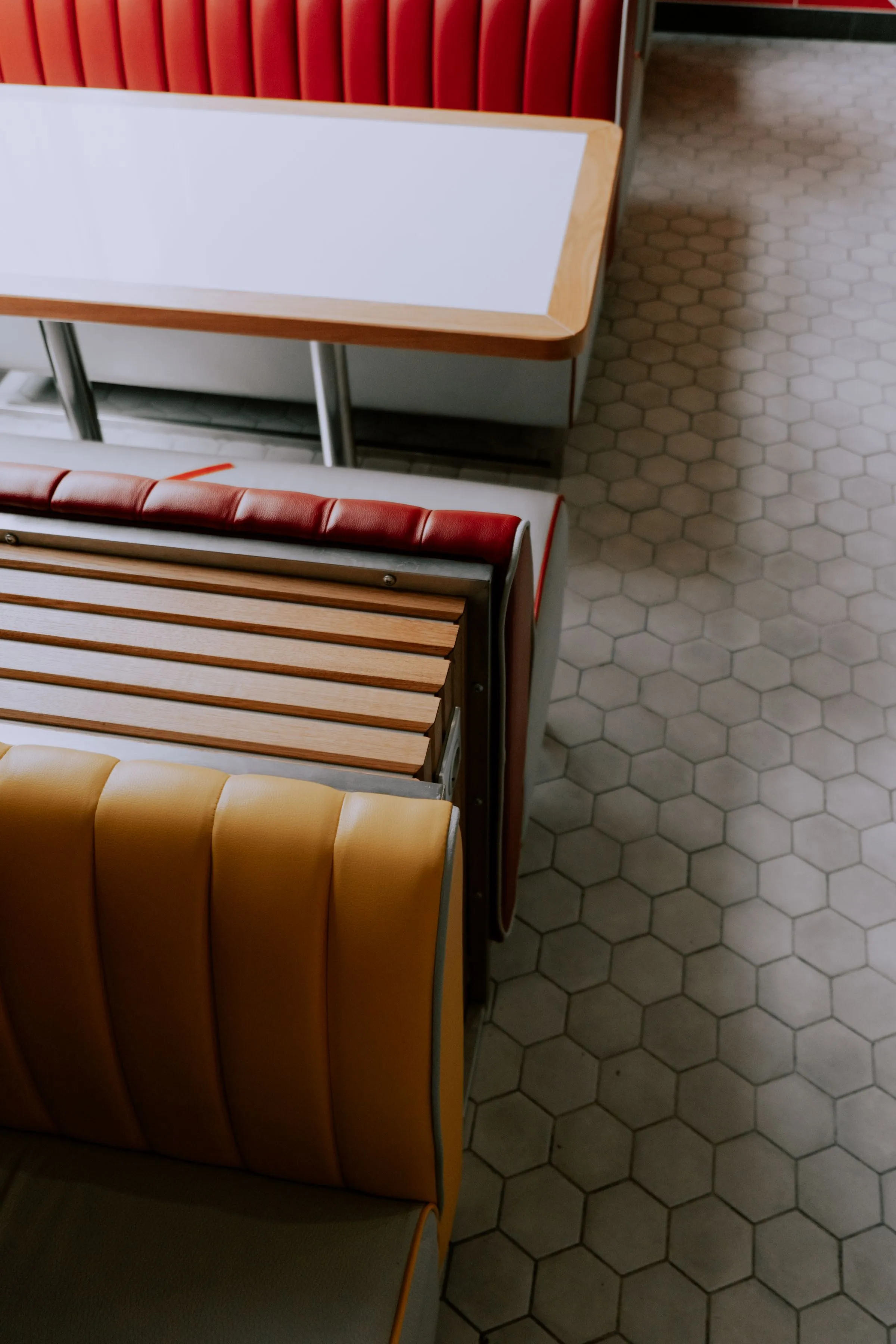 Booth seating in a café with patterned floor tiles.