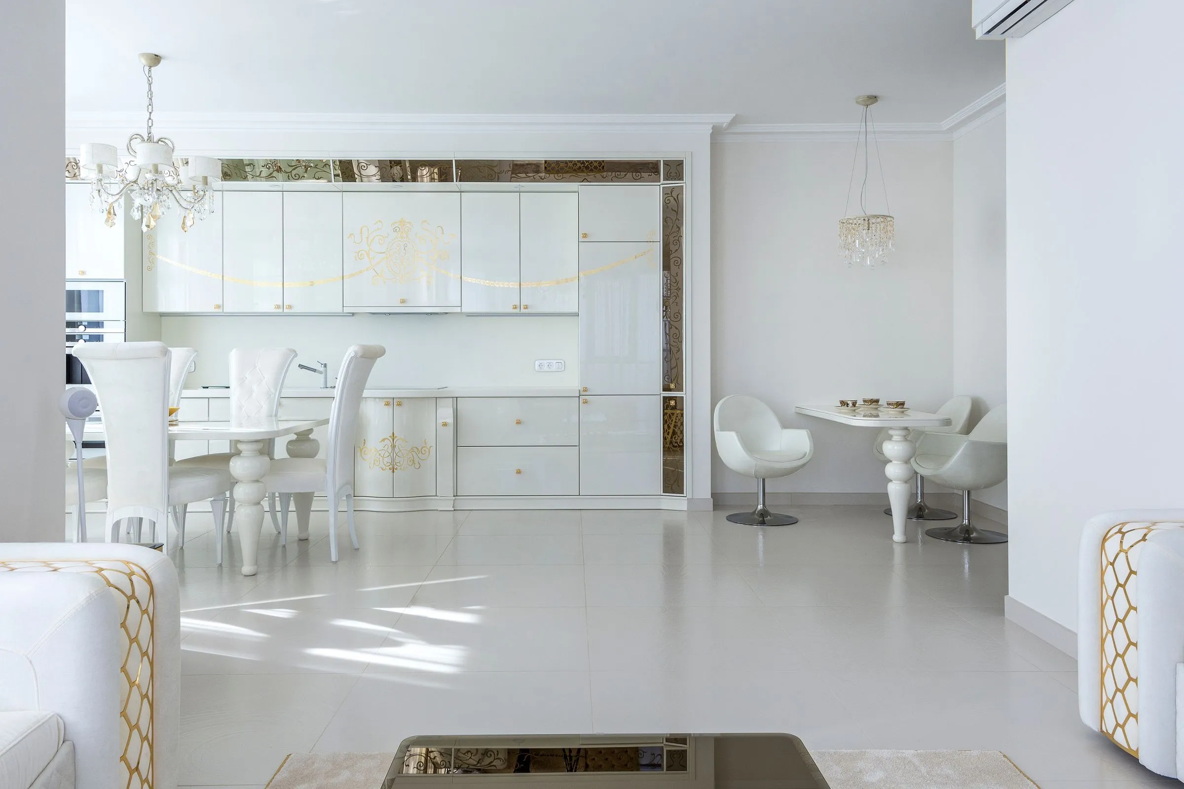 Compact kitchen and dining area at Kestrel House in white with timber accents.