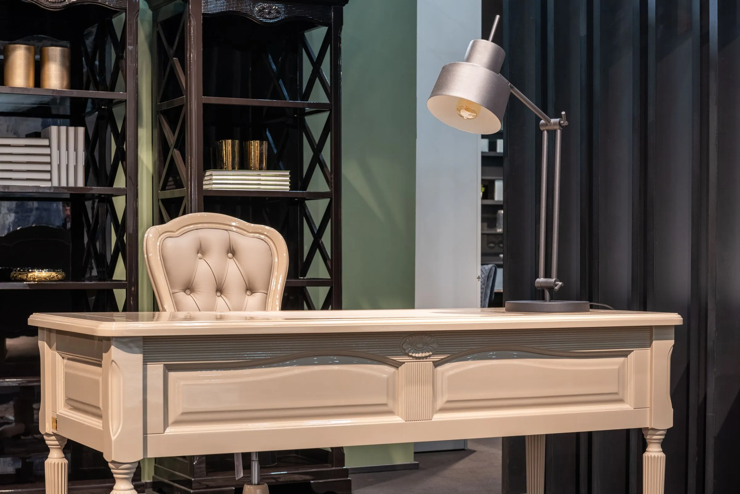 The Reading Room apartment with full-height bookshelves, a timber table and a reading lamp.
