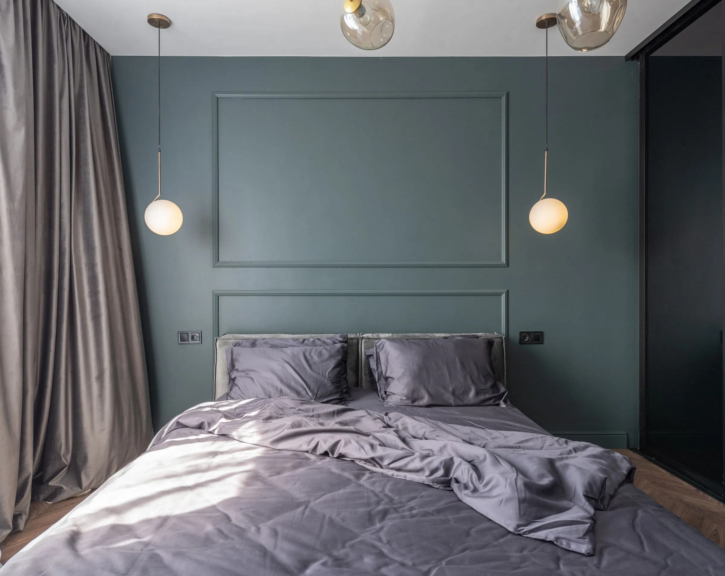 Bedroom at The Reading Room with morning light across an unmade bed.