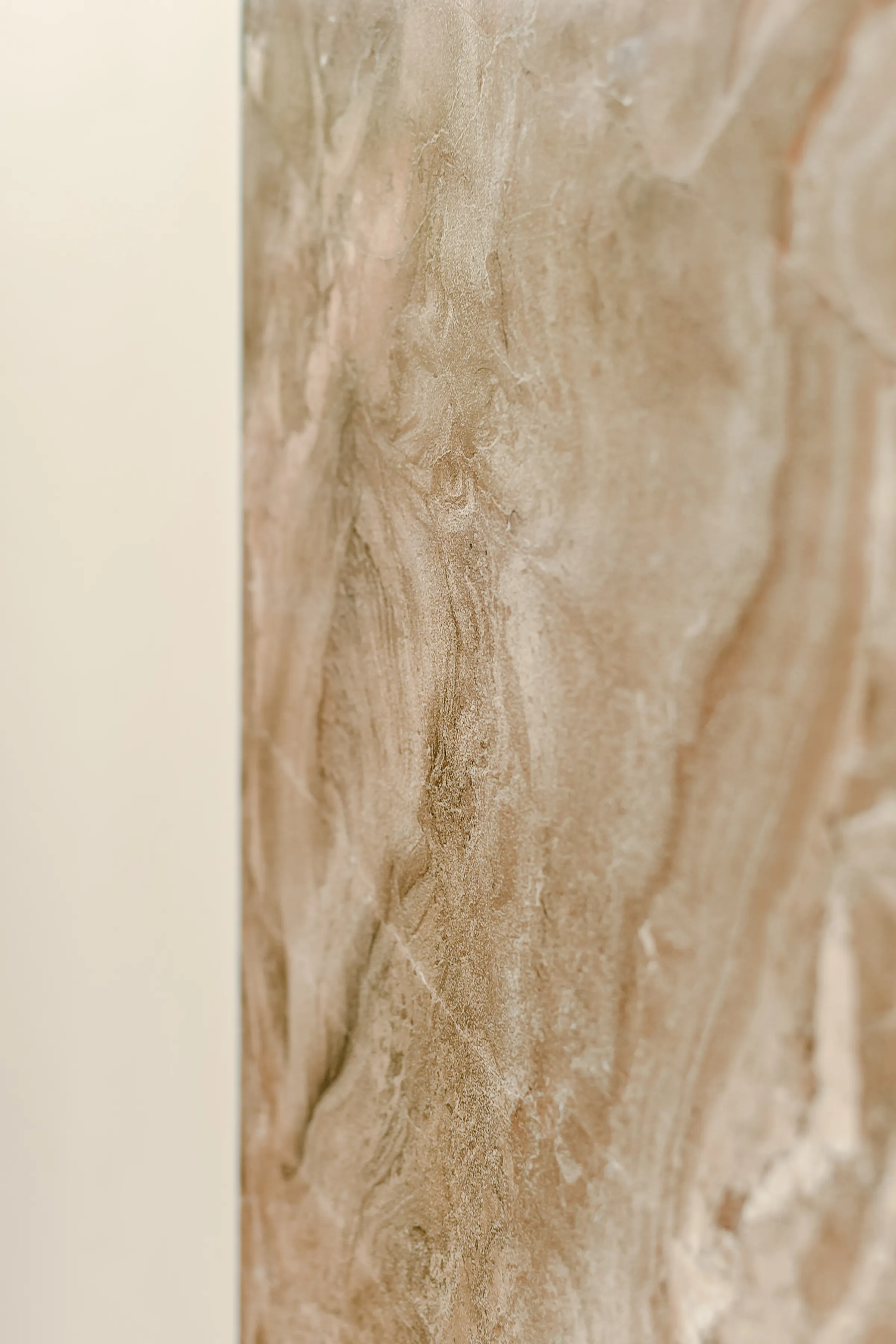 A close view of a pale marble surface with soft natural veining.