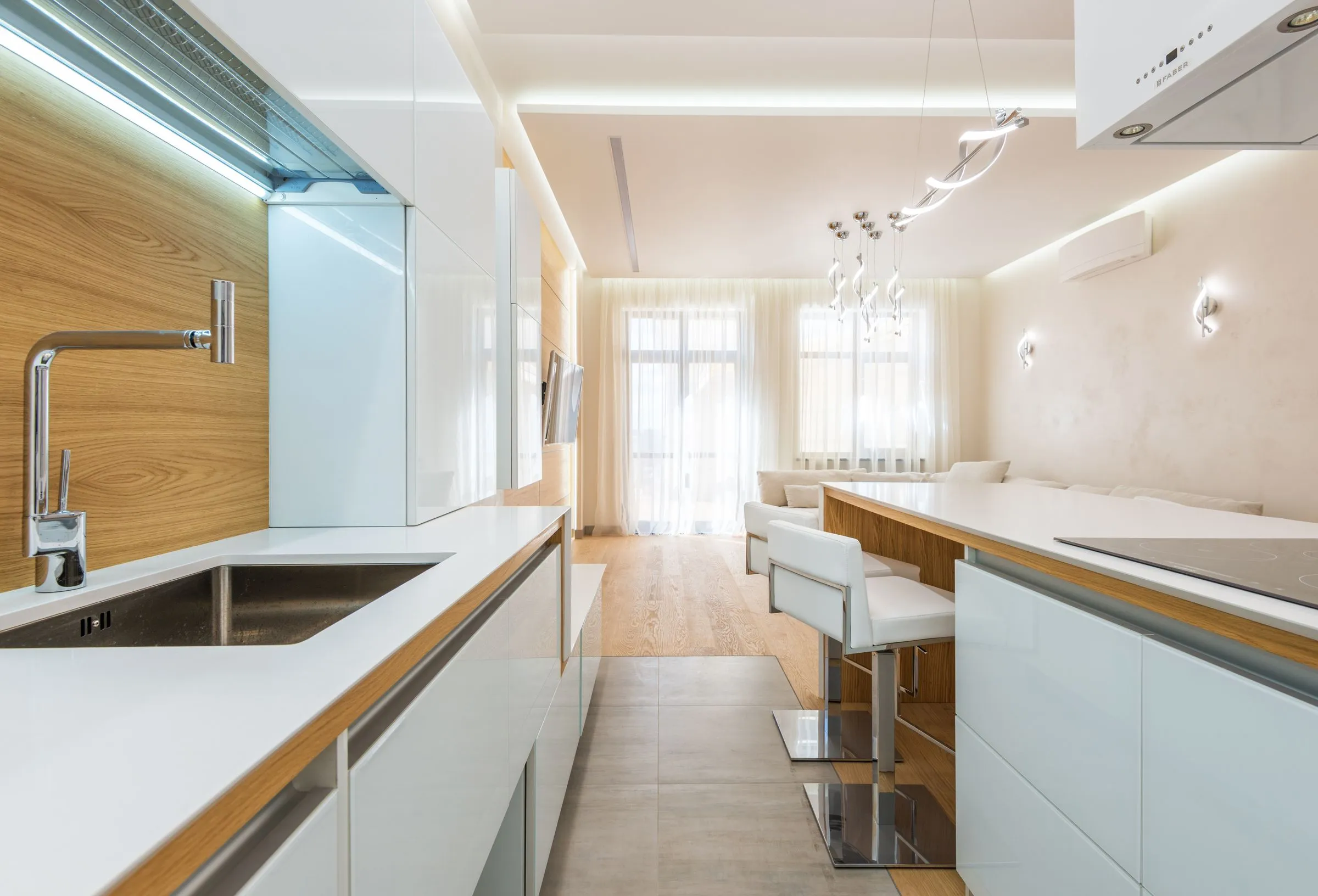 Kitchen at The Reading Room with white cabinetry and timber detailing in daylight.