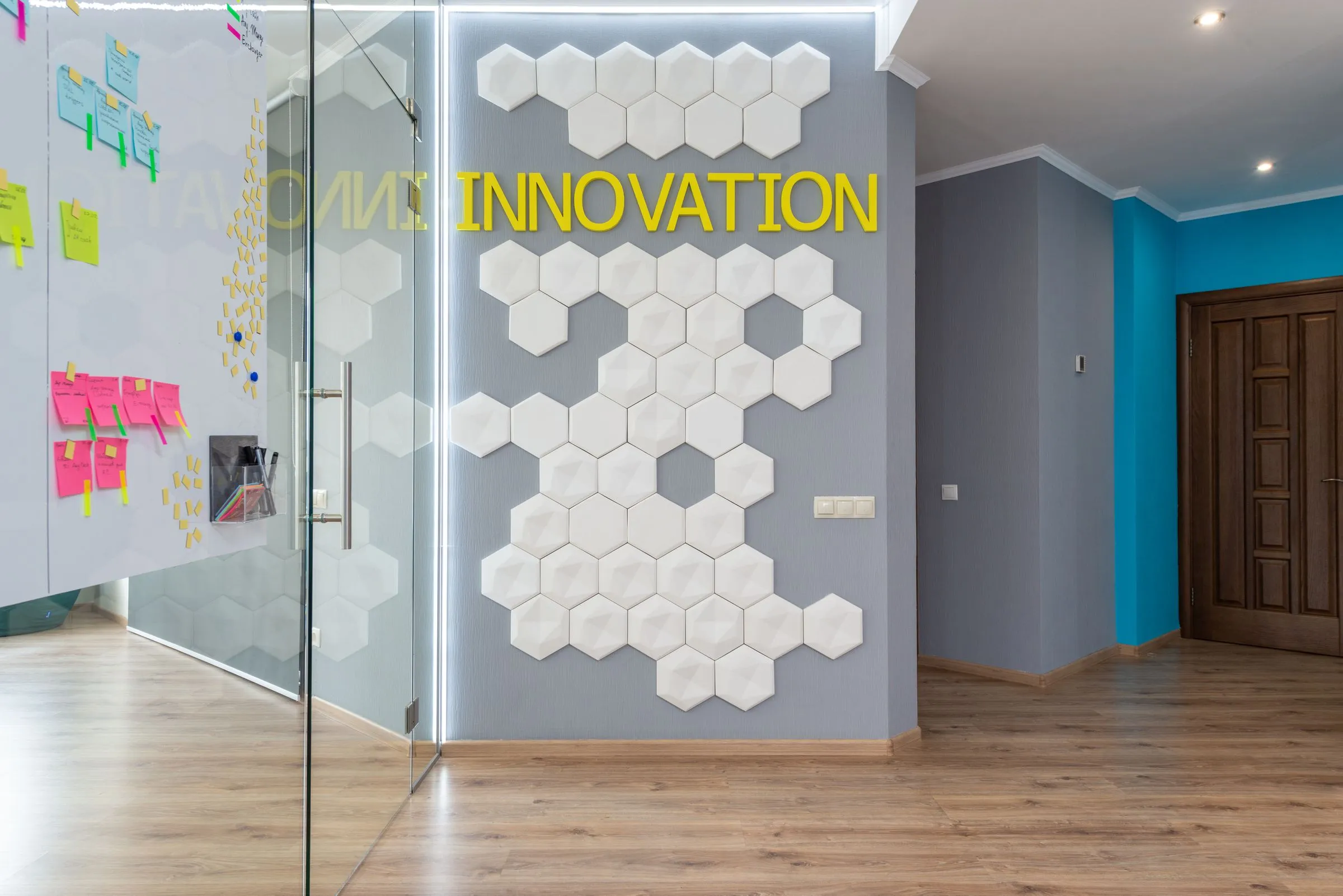 Wall detail at Northlight Studio beside the glazed meeting-room entrance.