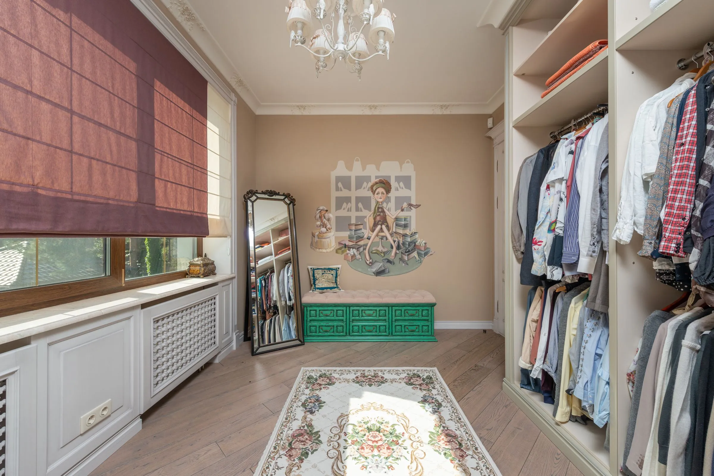 Dressing room at Maison No. 8 with hanging rails, a full-length mirror and a small chandelier.
