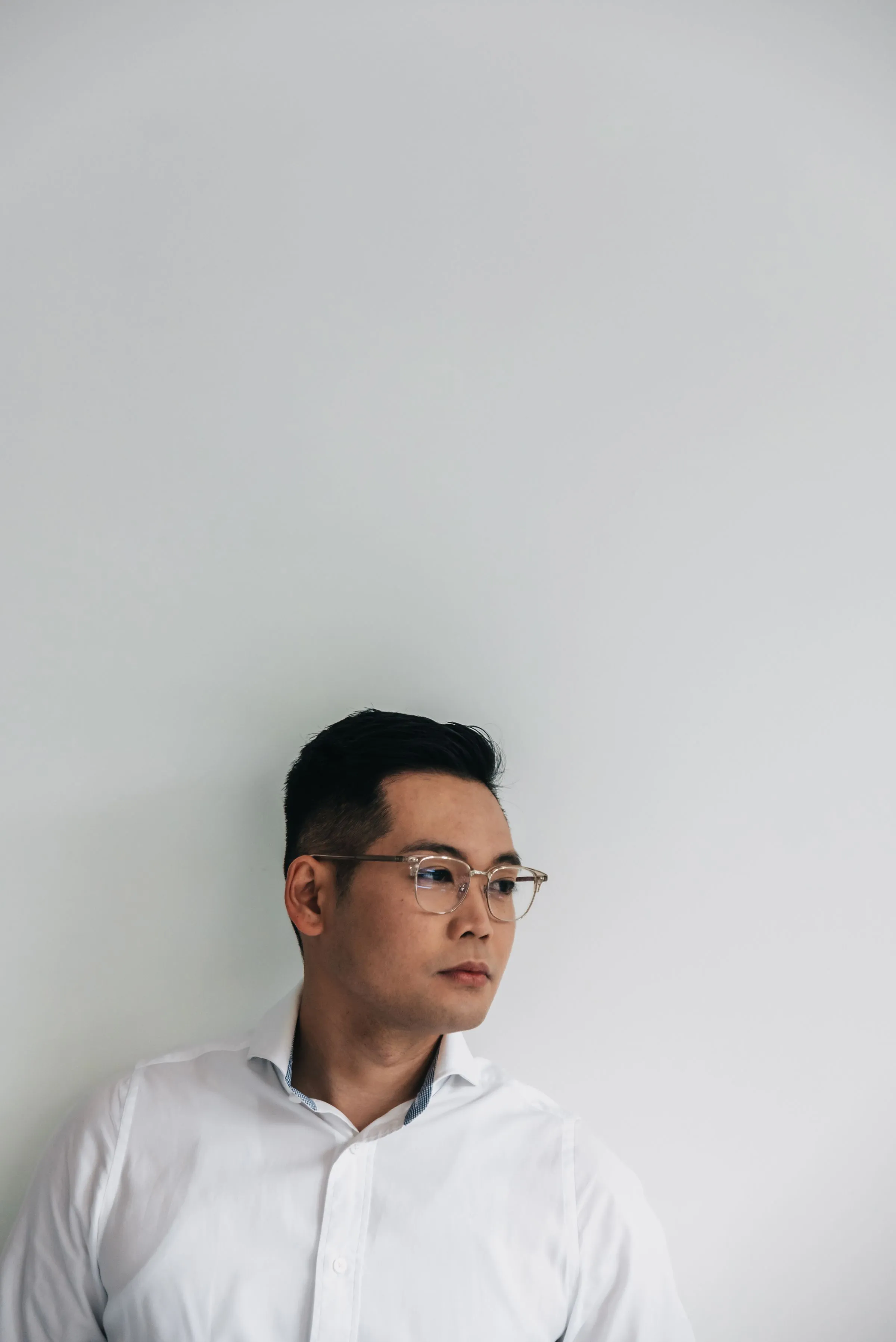 Portrait of Nikhil Sen, project manager, wearing glasses against a plain backdrop.