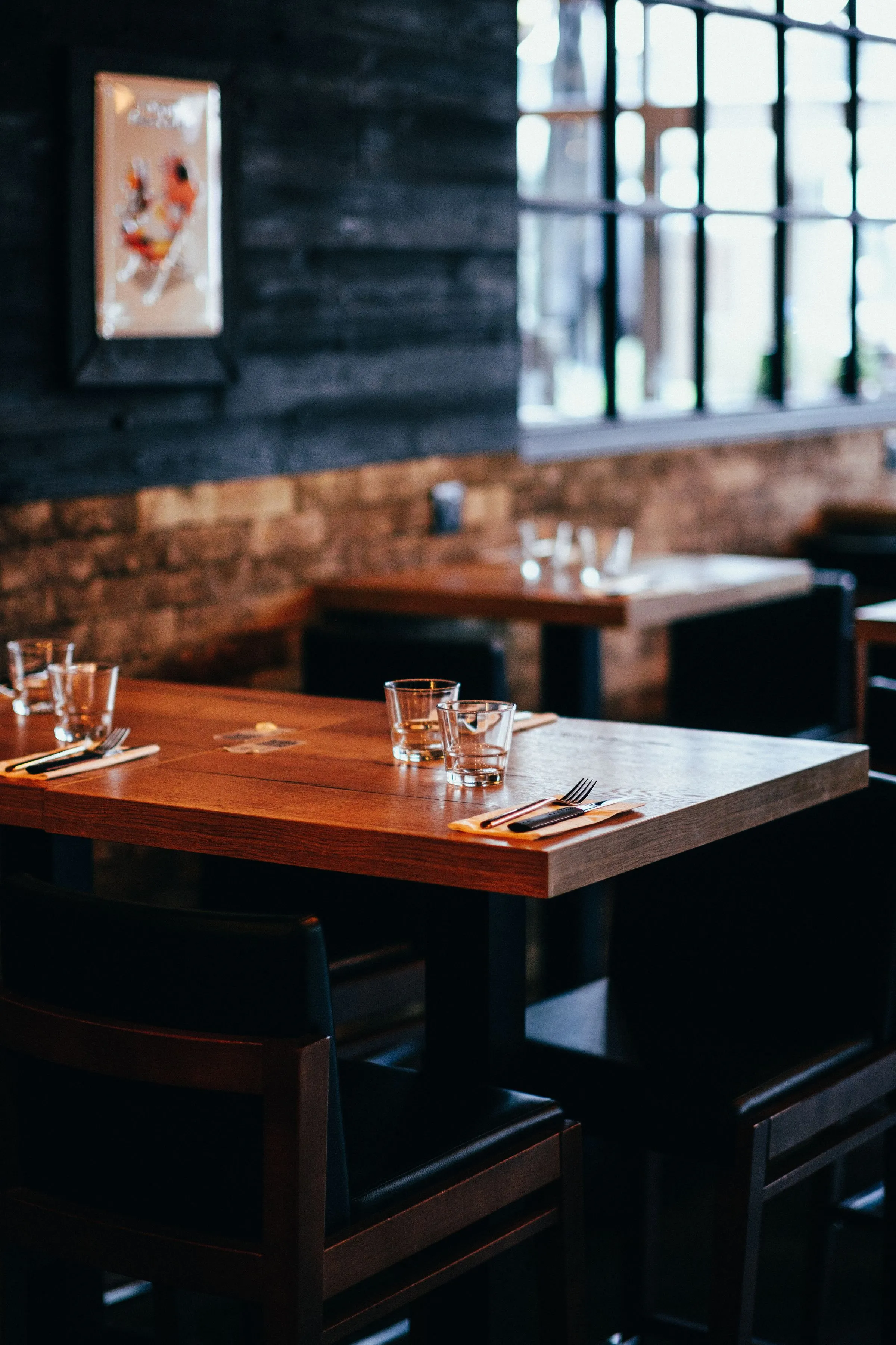 Table at The Salt Room laid with glassware under a warm table lamp.