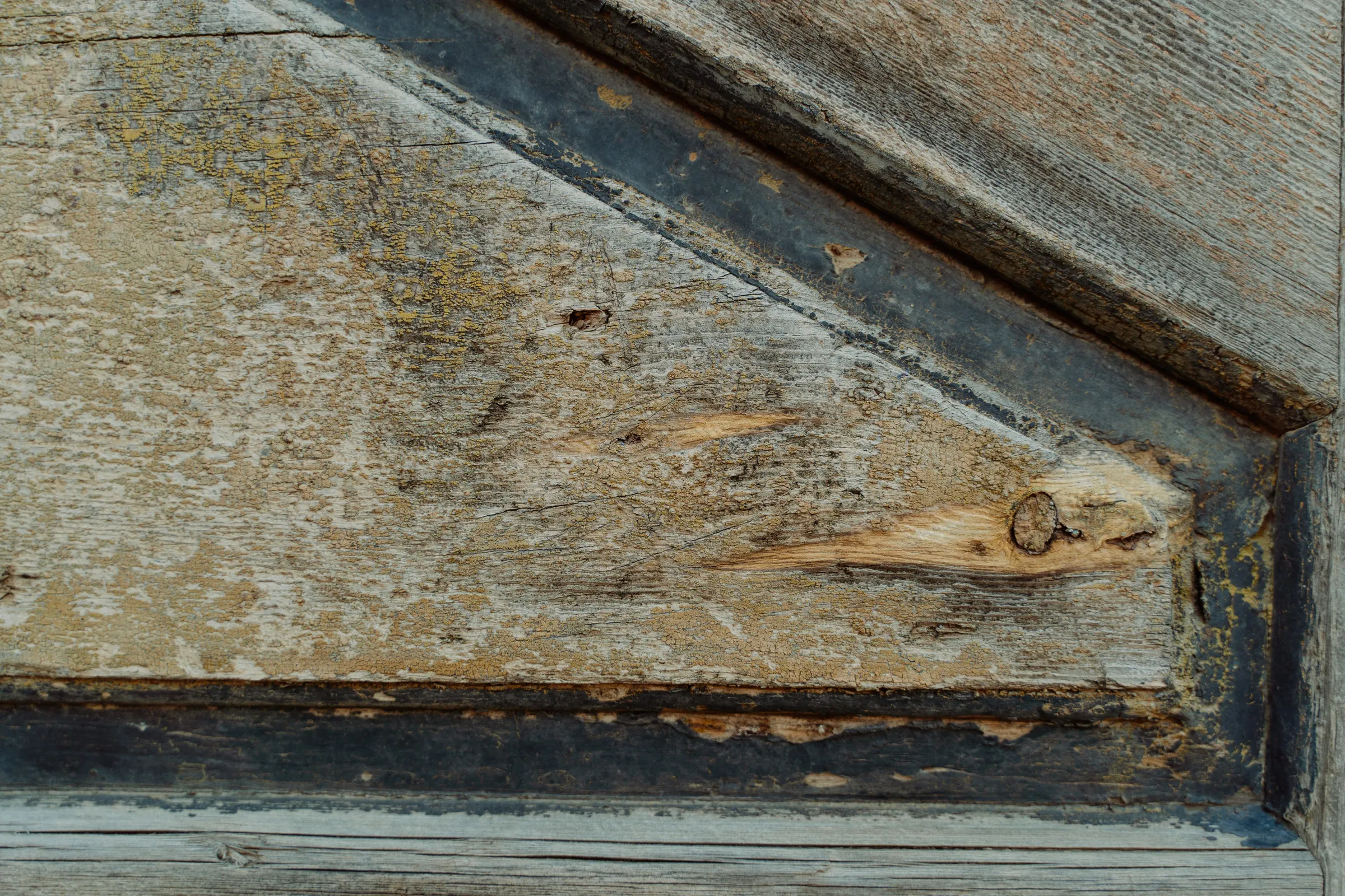 A close view of weathered timber showing pronounced grain and colour variation.