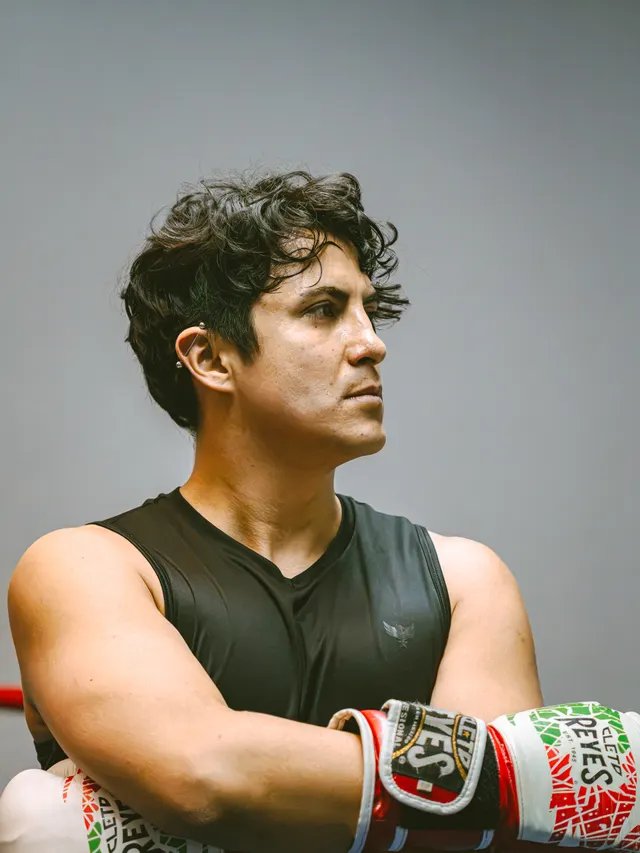 Portrait of a boxer with arms folded, gloves laced