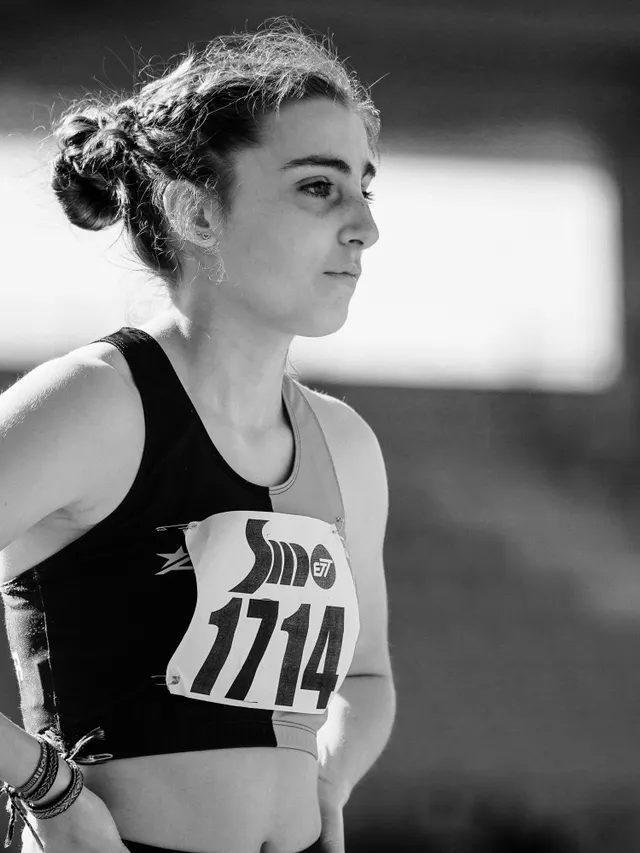 Portrait of a track athlete standing in an empty stadium