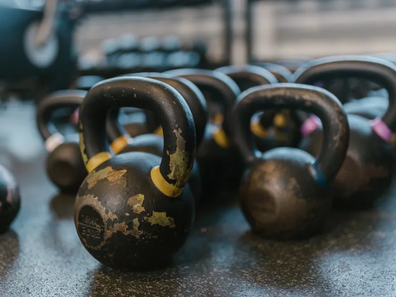 Kettlebells arranged on a textured rubber floor