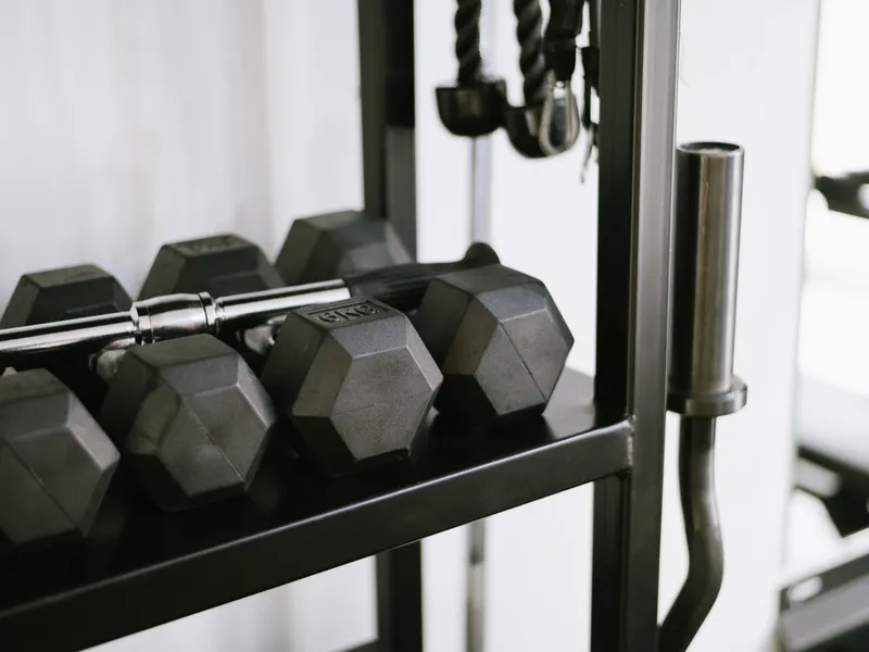 Hex dumbbells racked in order along a steel rack