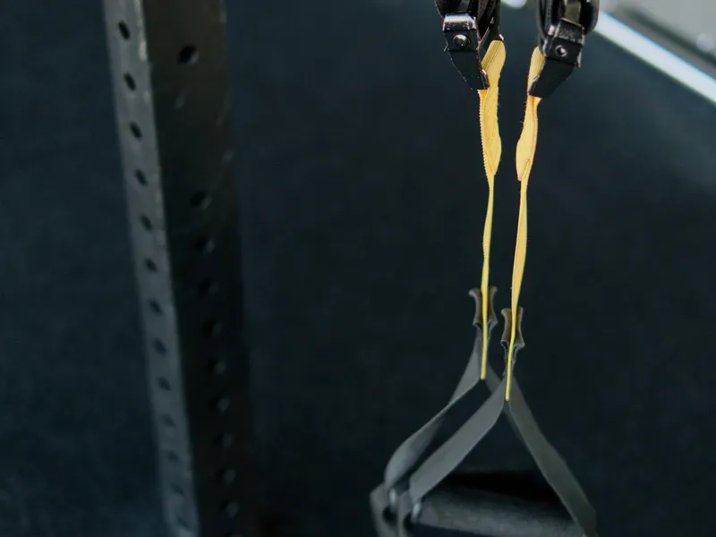 Suspension trainer hanging from a rig in low light