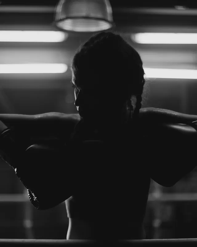 Boxer resting against the ropes between rounds