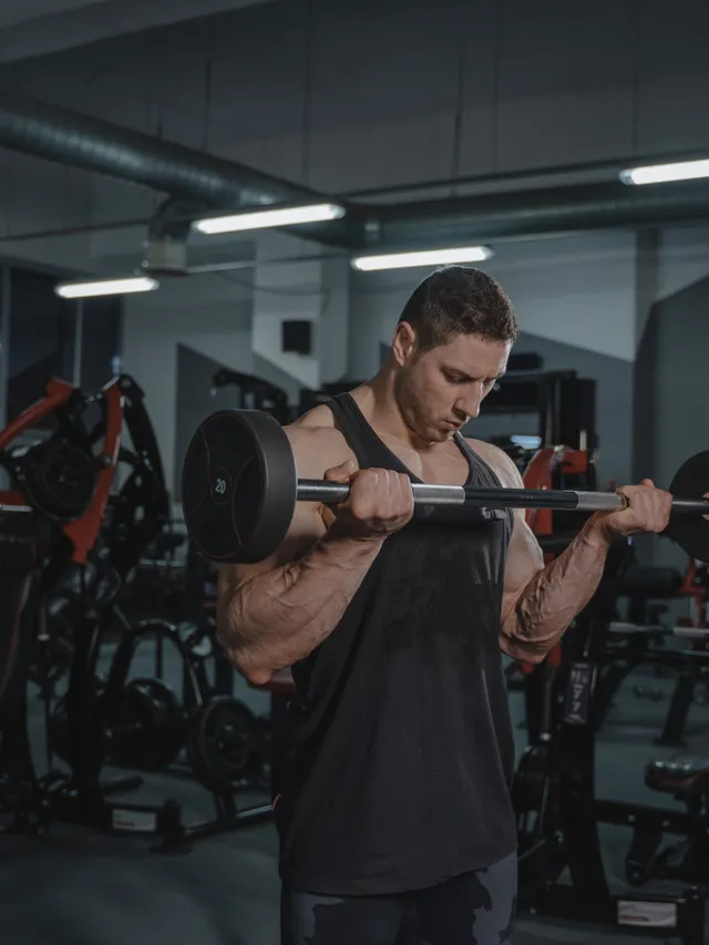 Coach and lifter working through a barbell set together