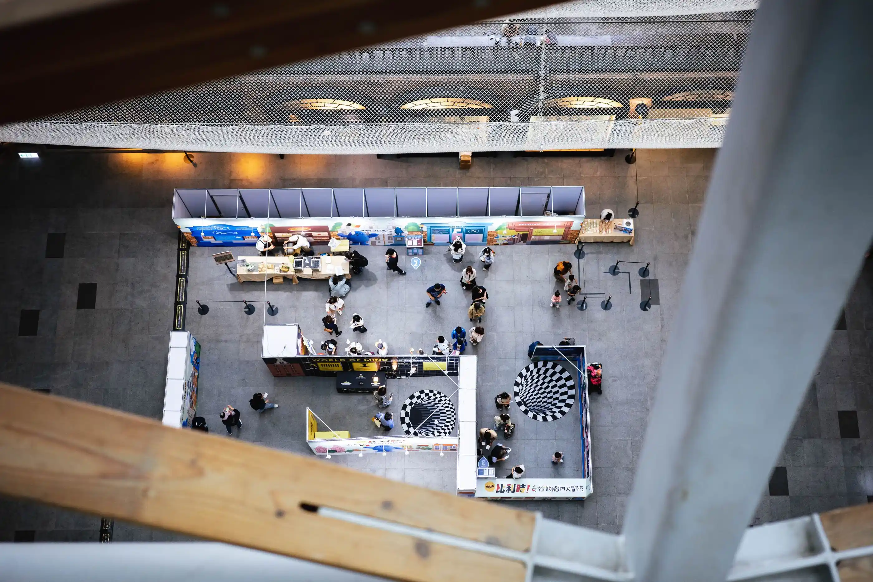 An exhibition floor seen from above, stands and walkways laid out in a grid