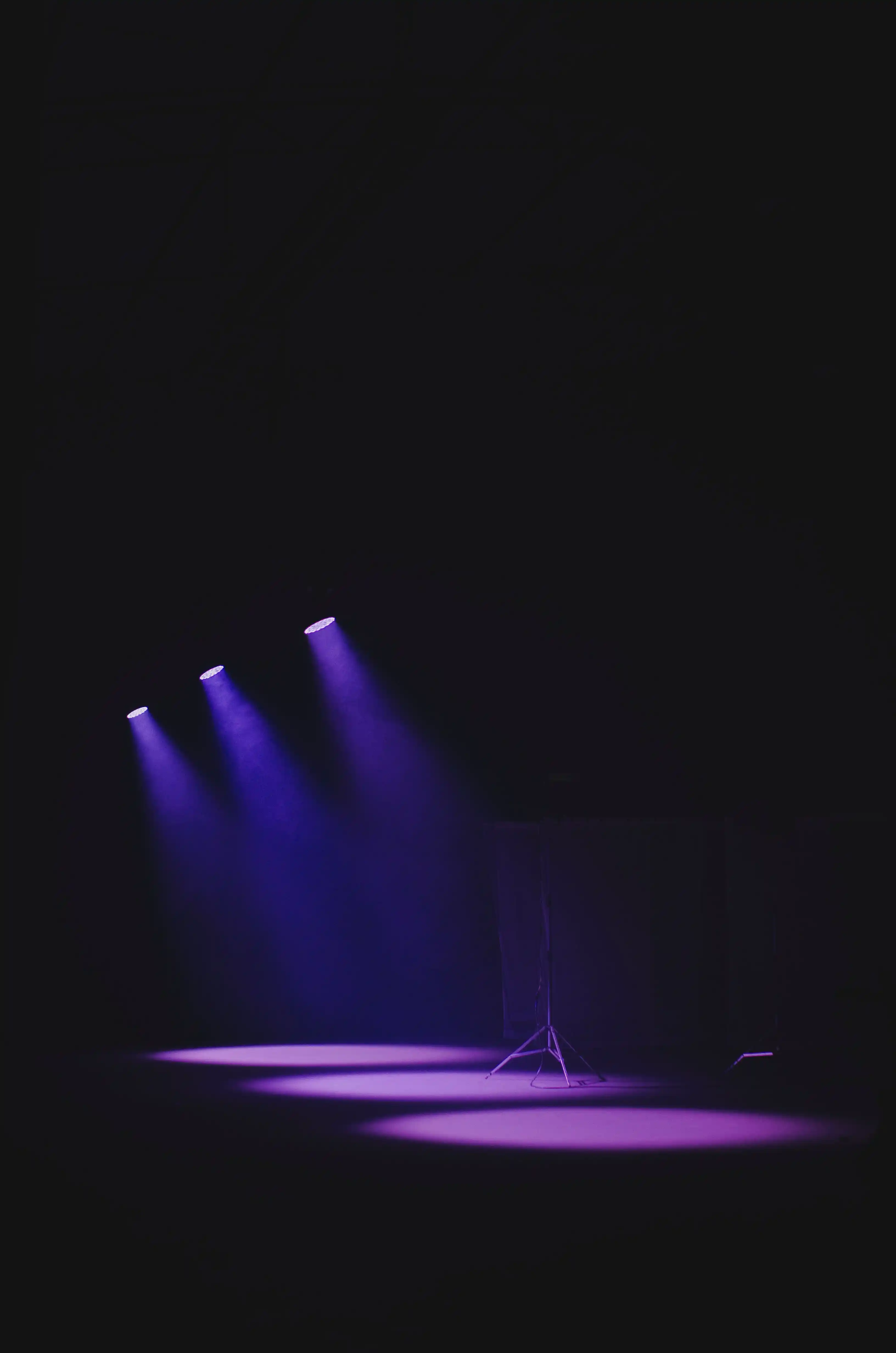 An empty stage washed in purple spotlight, waiting for the first award of the night