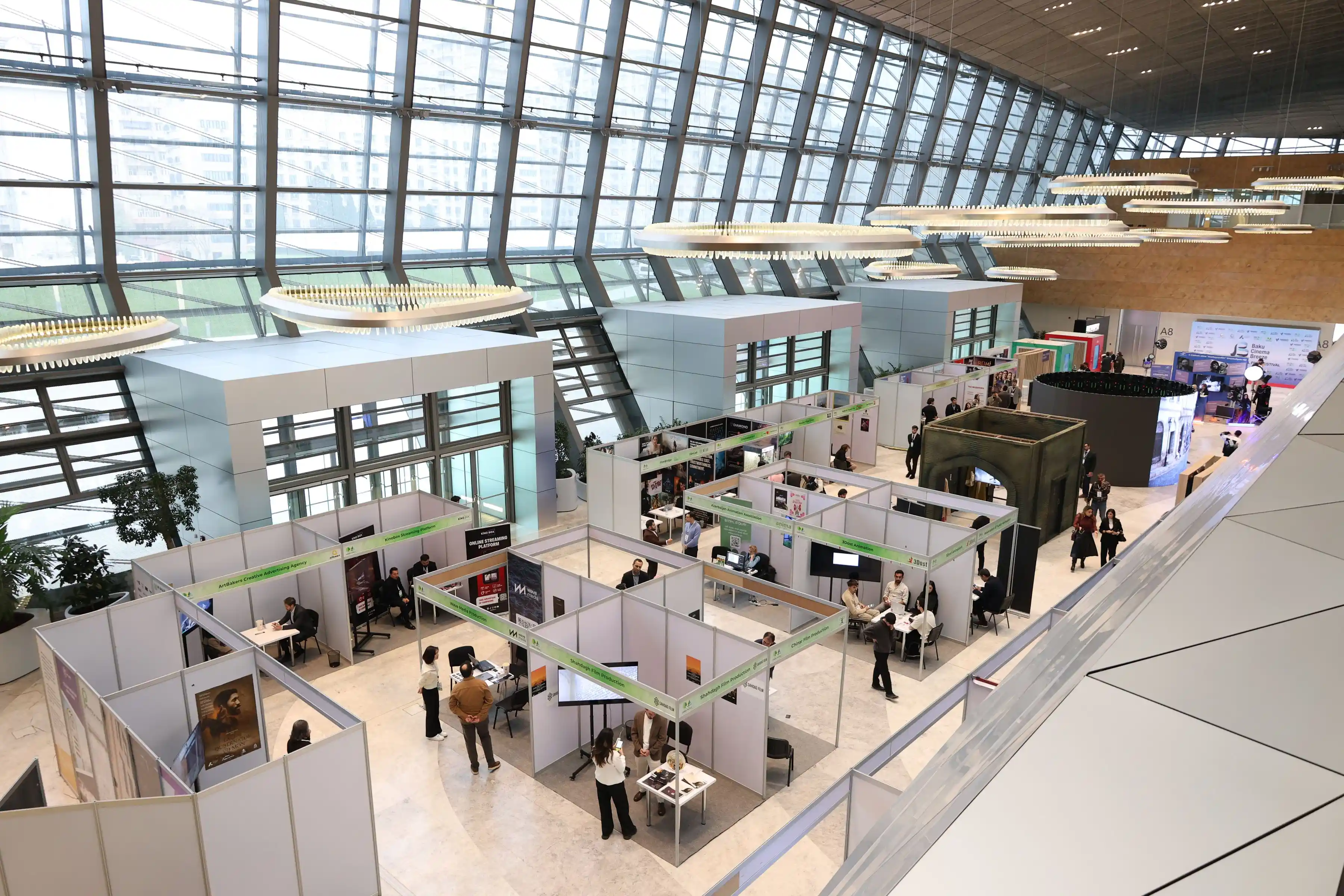 An exhibition hall busy with visitors moving between stands