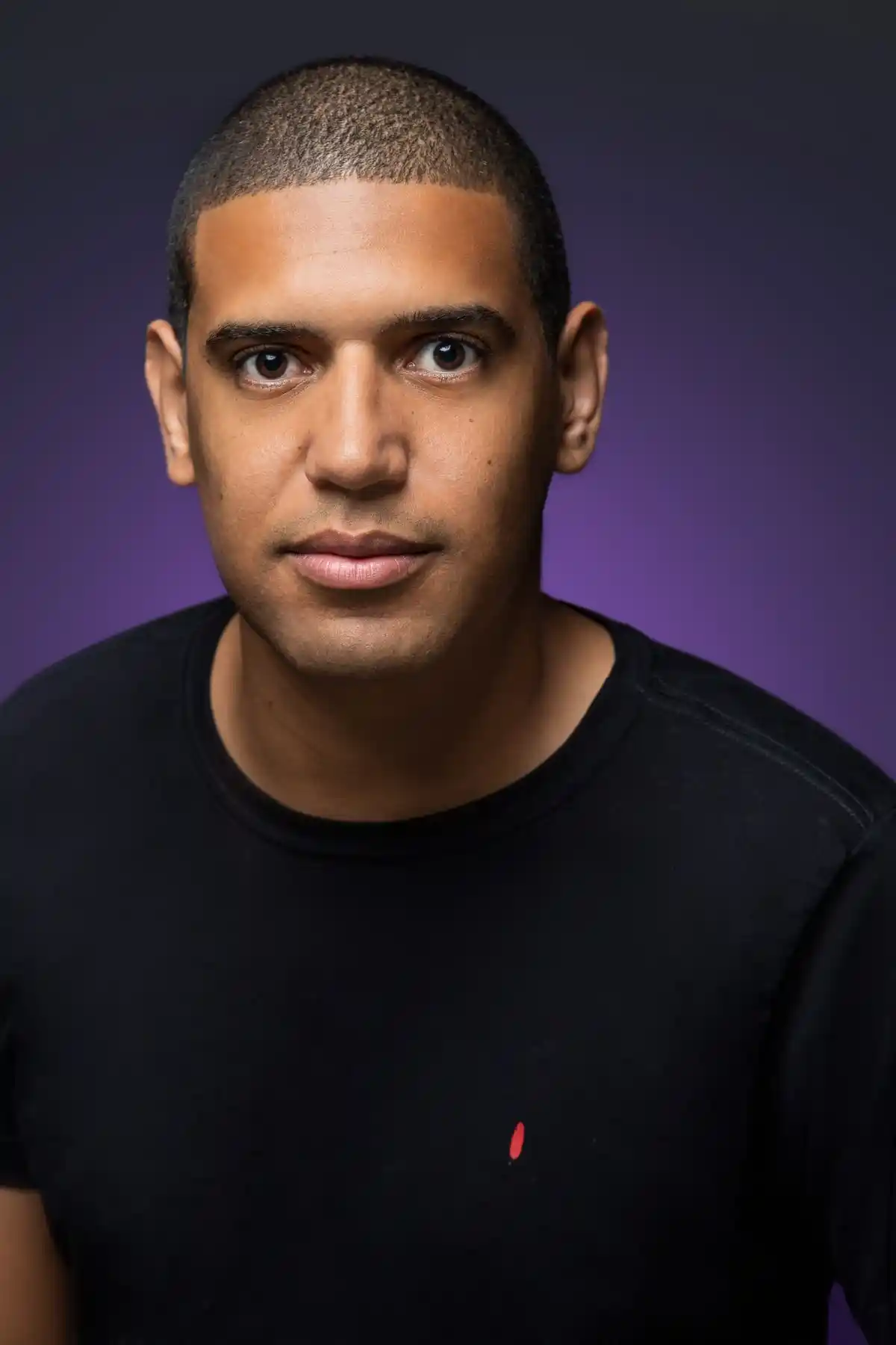 Studio portrait of a man in a black shirt