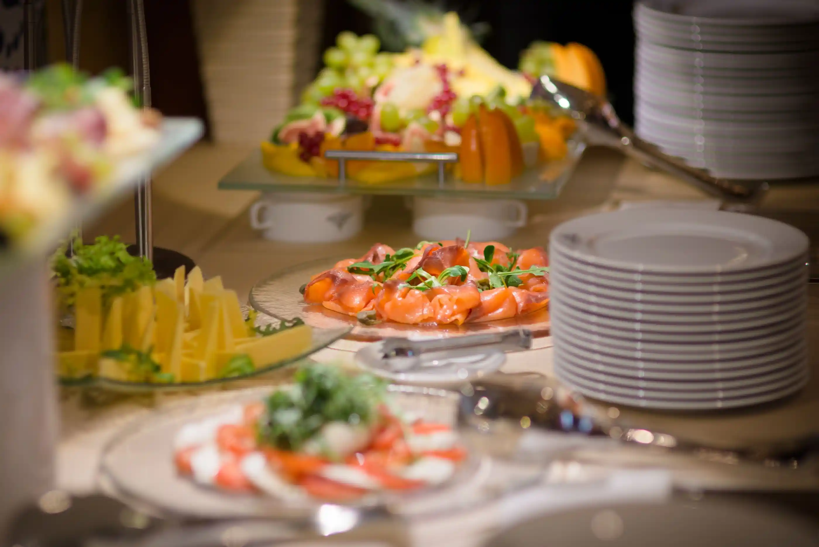 A buffet of cold dishes, cured fish and fruit on tiered stands
