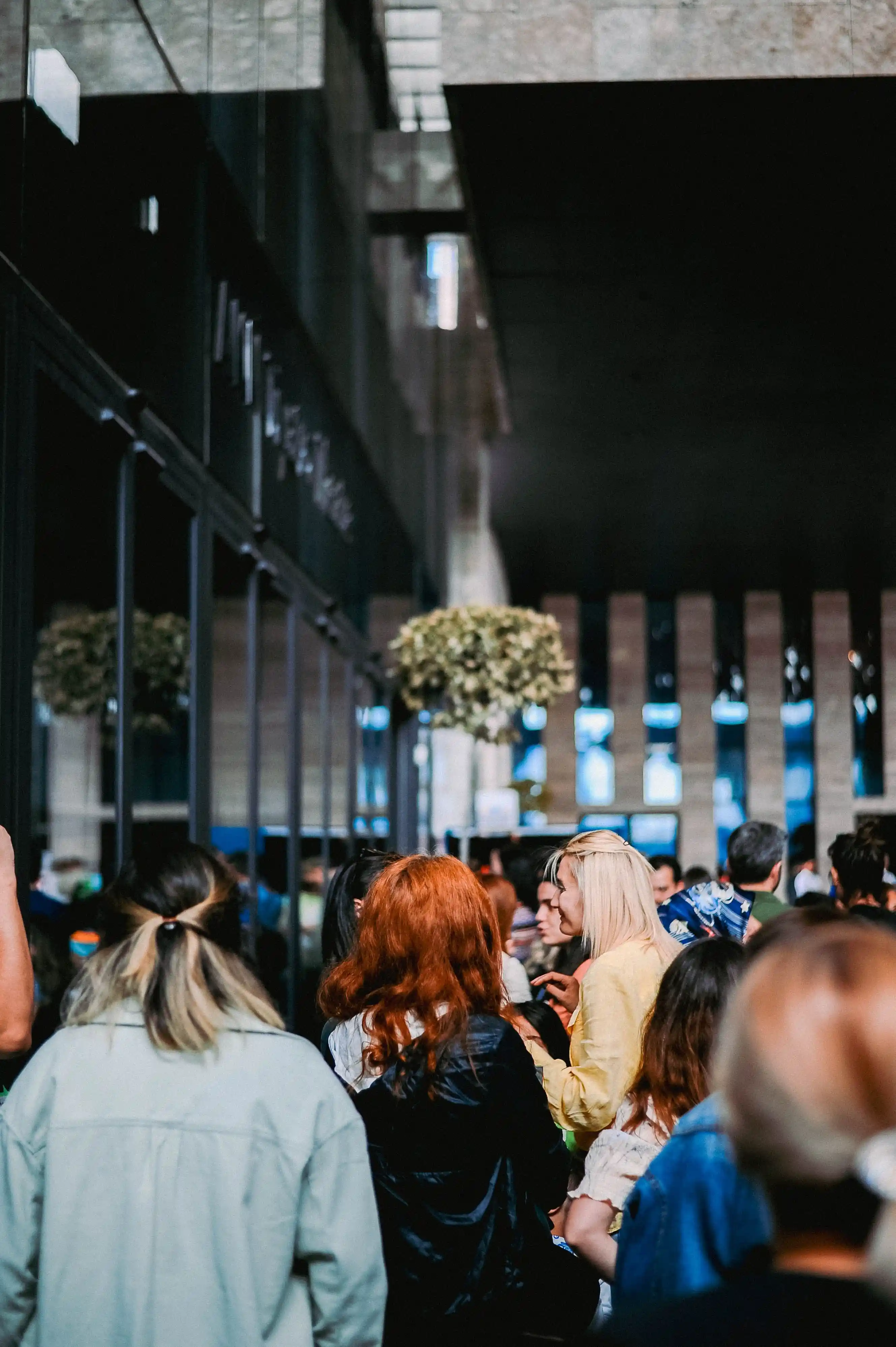 Visitors moving through the atrium of a large exhibition building