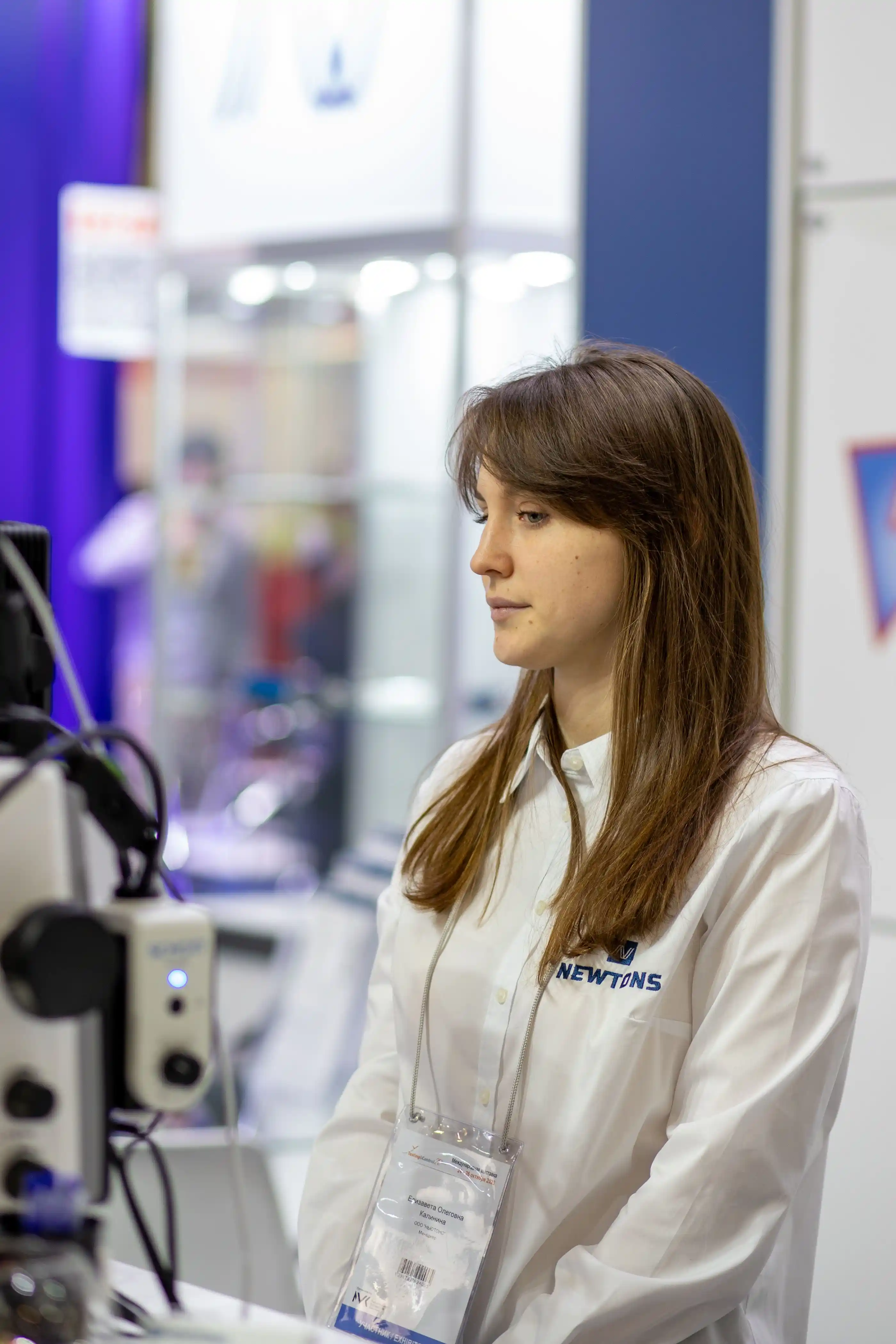 A stand host waiting to greet visitors at an exhibition booth