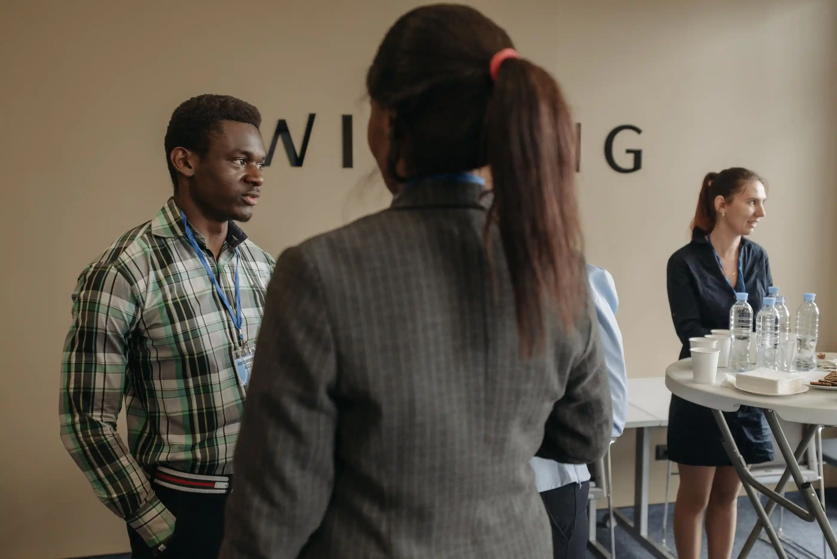 Delegates standing in conversation at a networking break