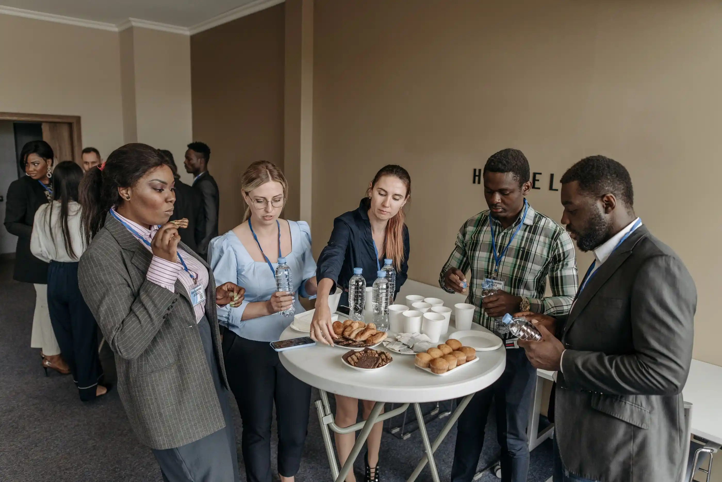 Guests around a cocktail table with canapés and drinks
