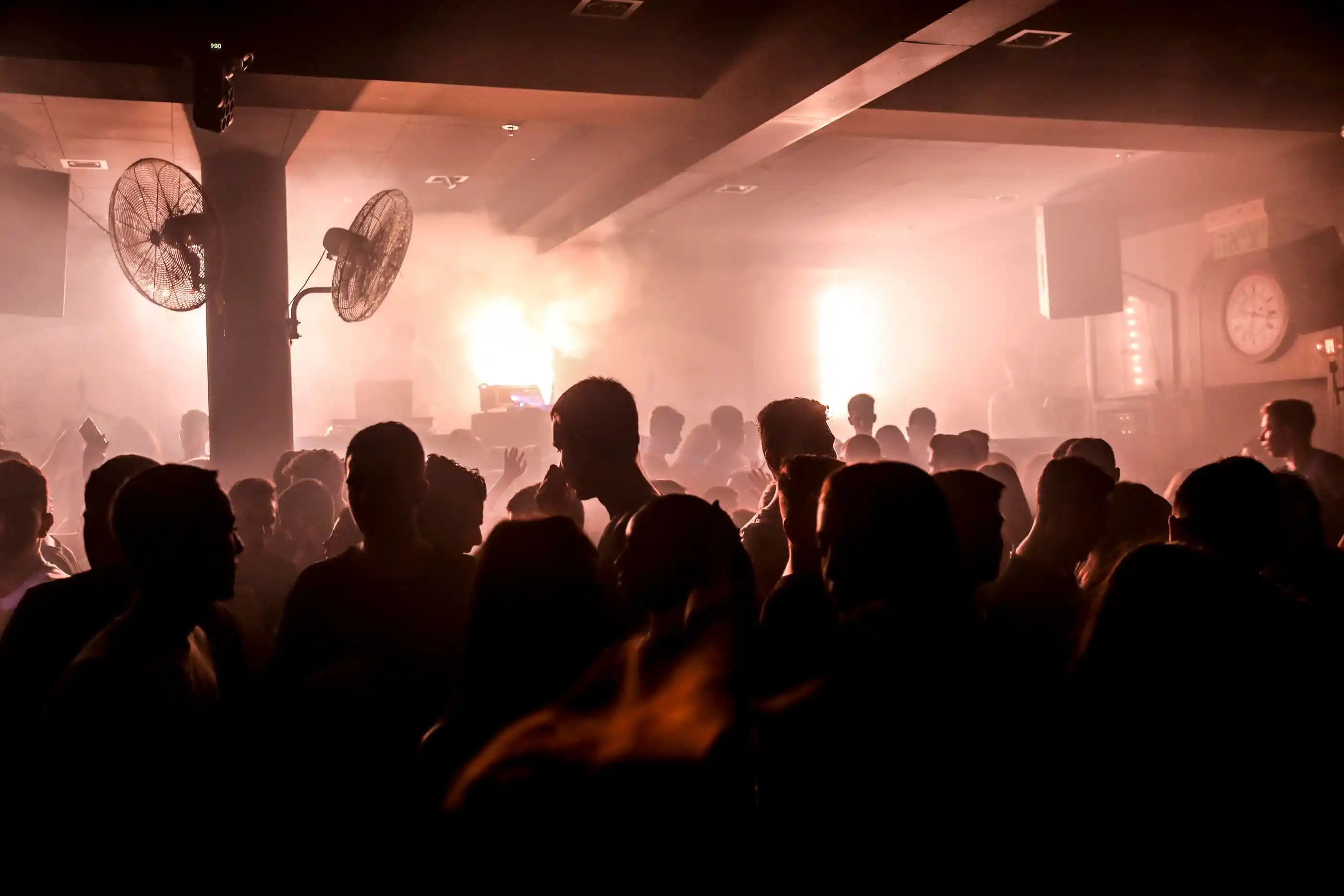 Silhouettes of dancers in heavy haze and coloured light