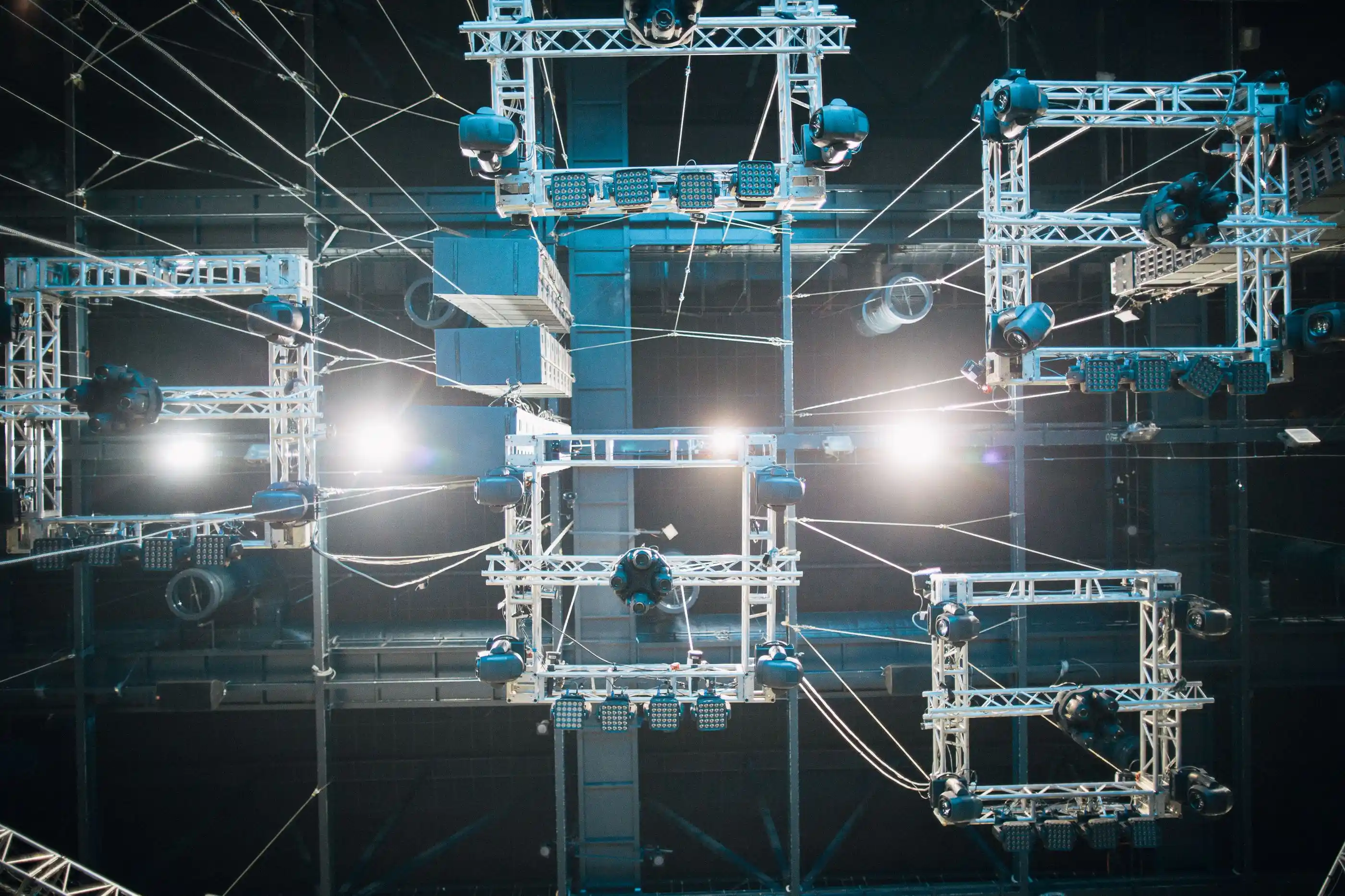 A screen and rigging seen from above, ropes and steel overhead