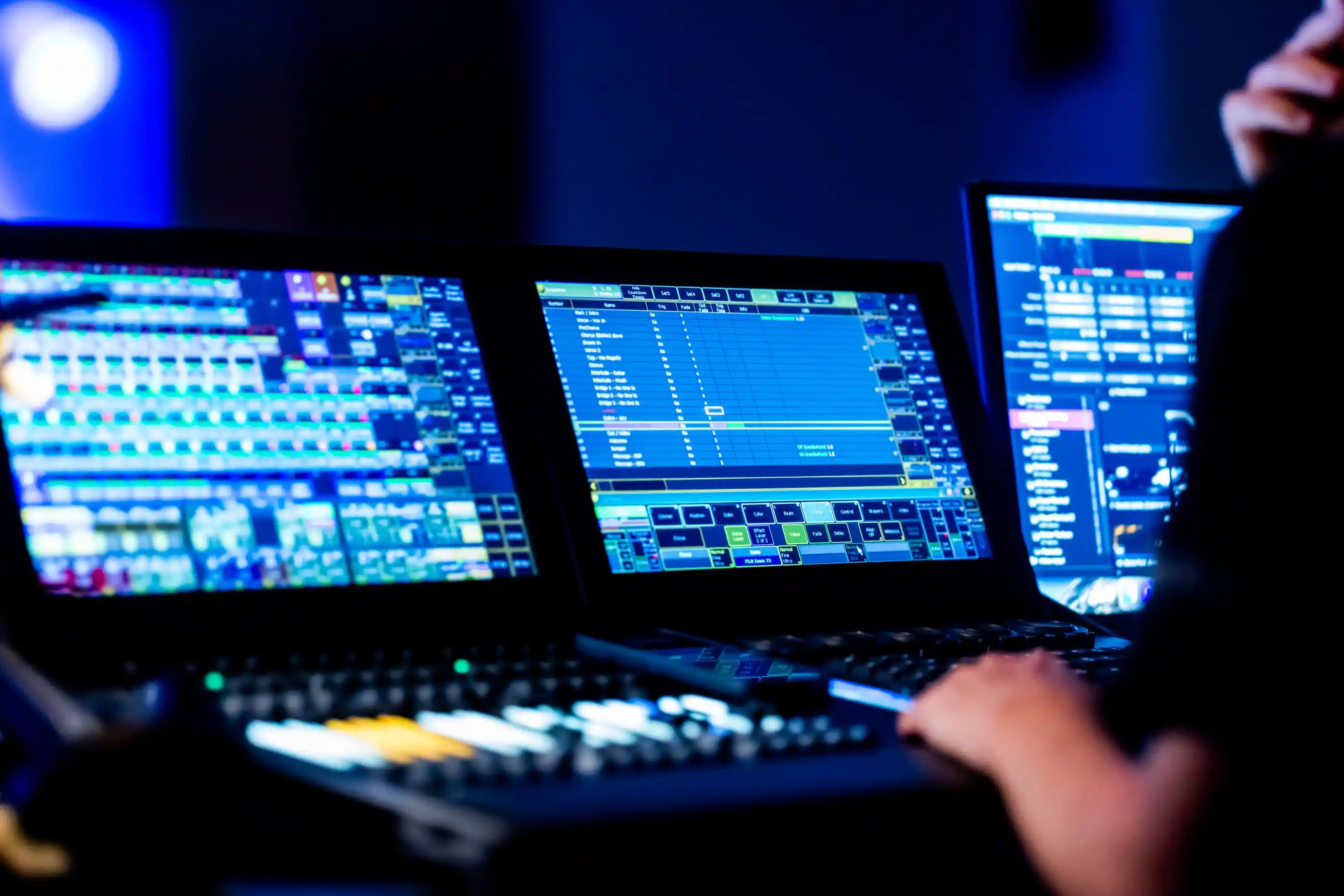 A sound engineer working a digital mixing console during a show