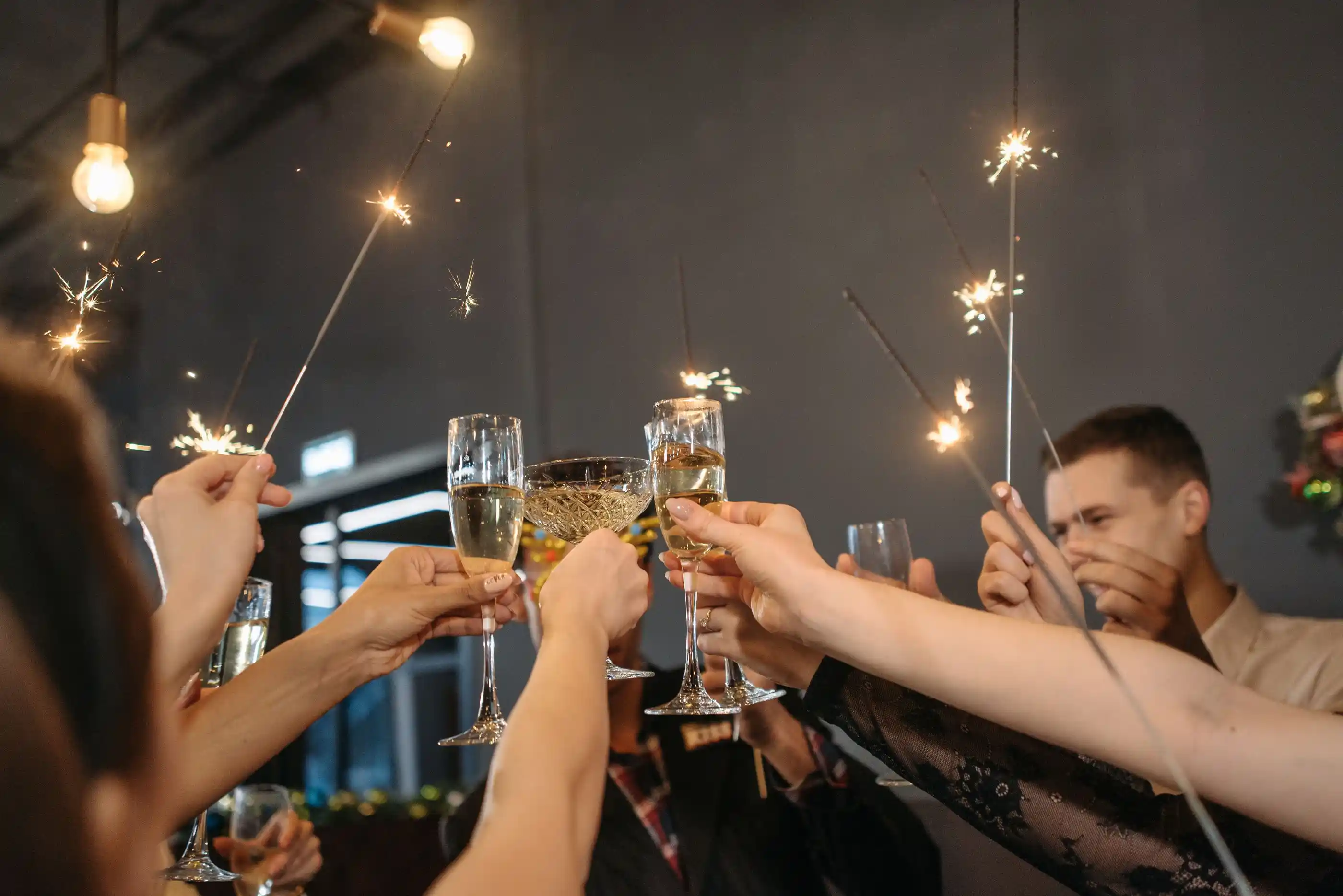 Guests toasting with sparklers lit around them